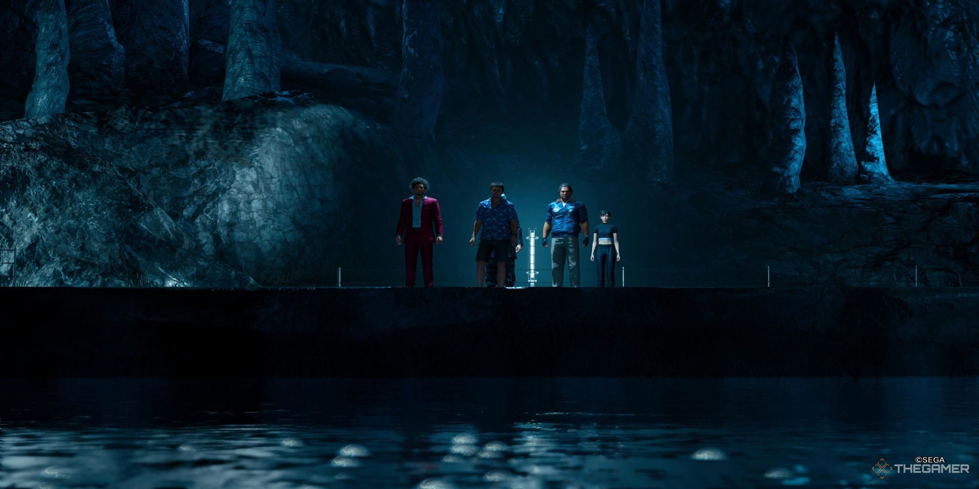 A screenshot from Like a Dragon Infinite Wealth showing Ichiban, Tomizawa, Joonghi, Adachi, and Chitose standing on a raised platform behind some bubbling water in the foreground. 