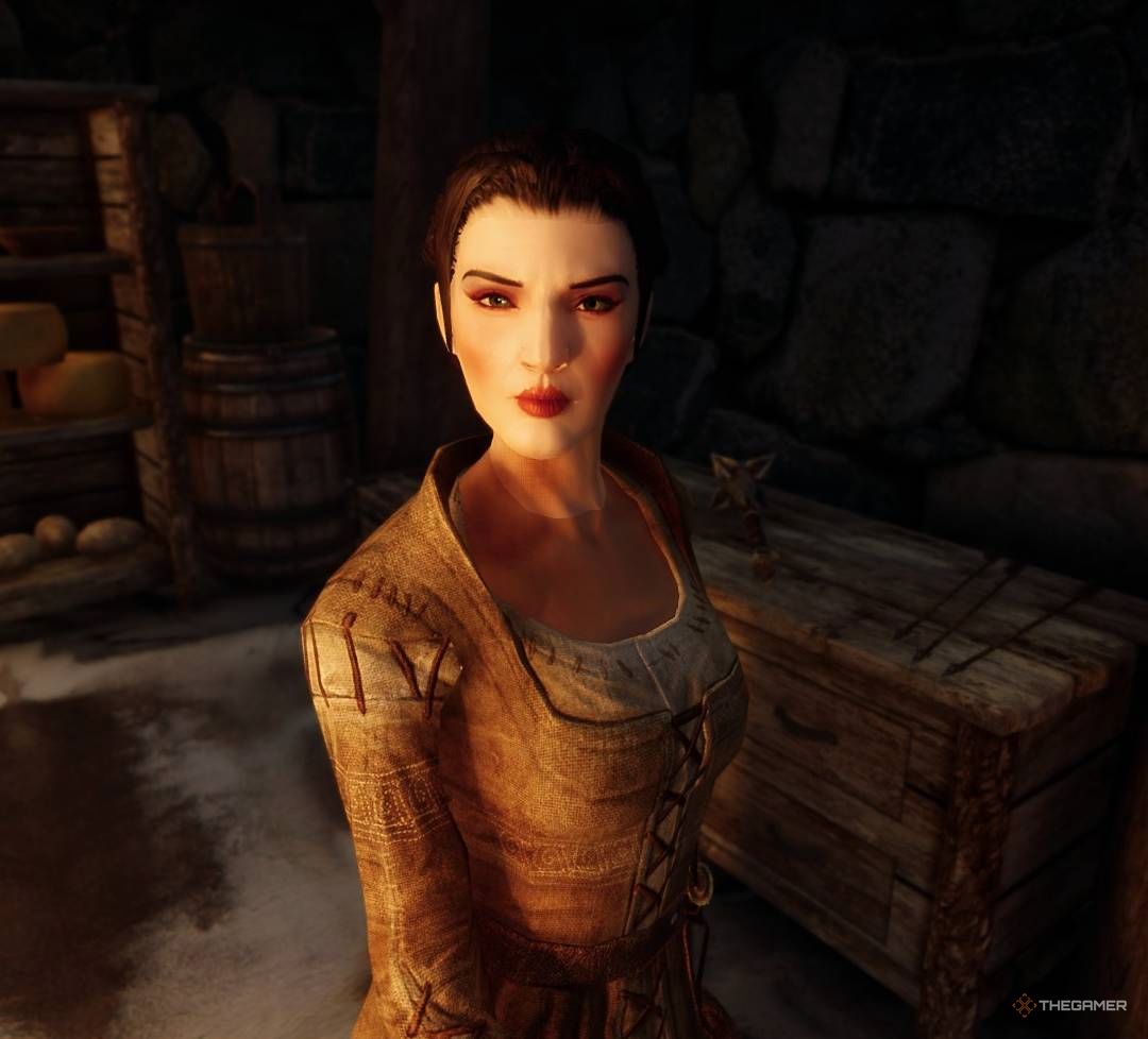 Camilla Valerius scowls toward camera inside the Riverwood Trader, Skyrim.