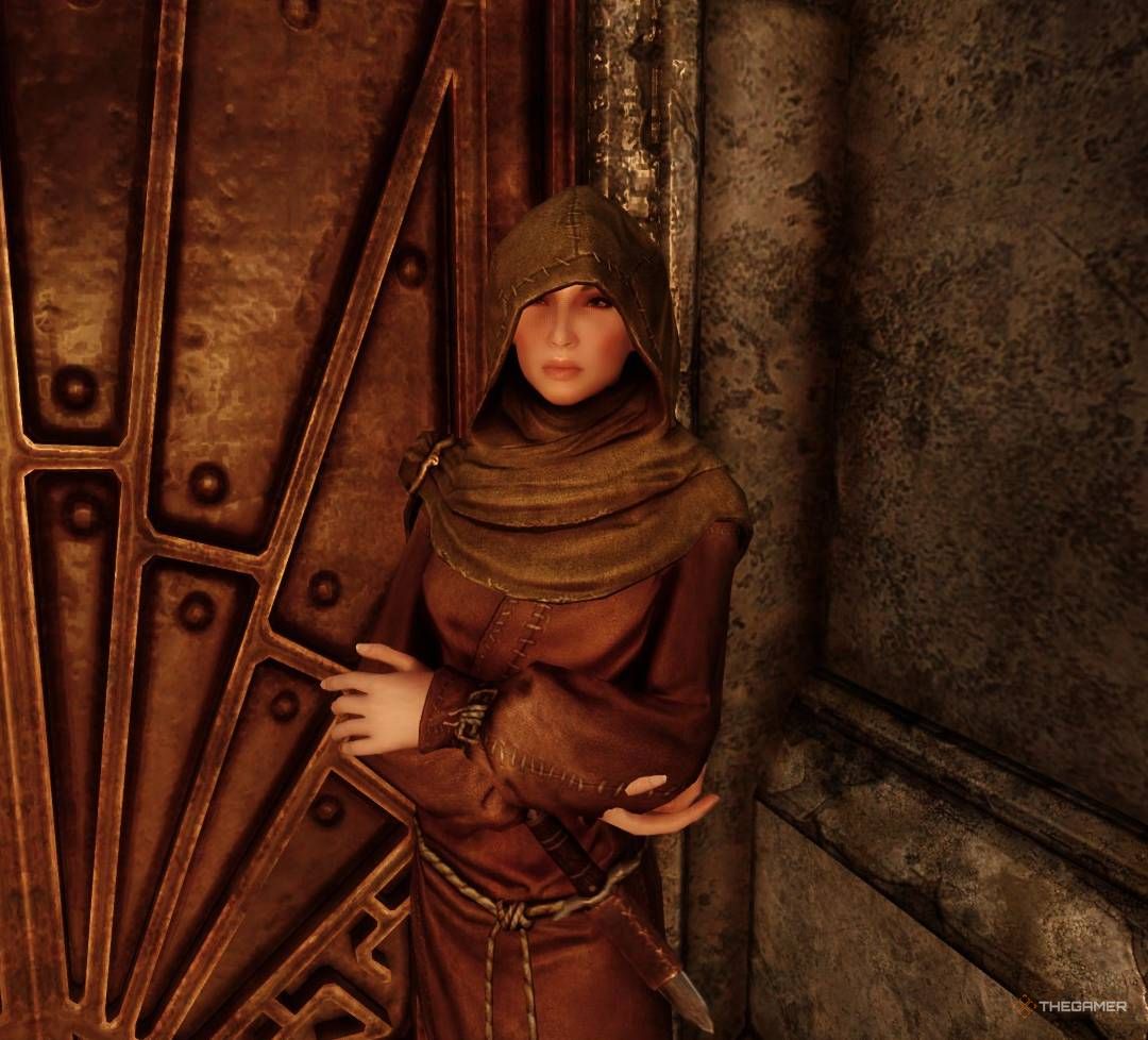 Orla stands beside door connecting Inner and Deeper Temple of Dibella in Skyrim.