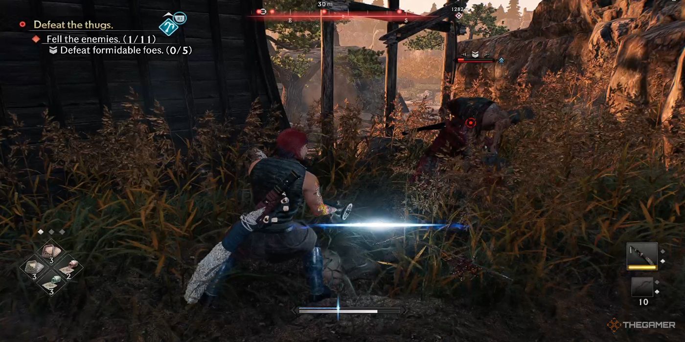 The protagonist cleans his sword with a fast Blade Flash after striking down a bandit near a rural store house in Rise Of The Ronin.
