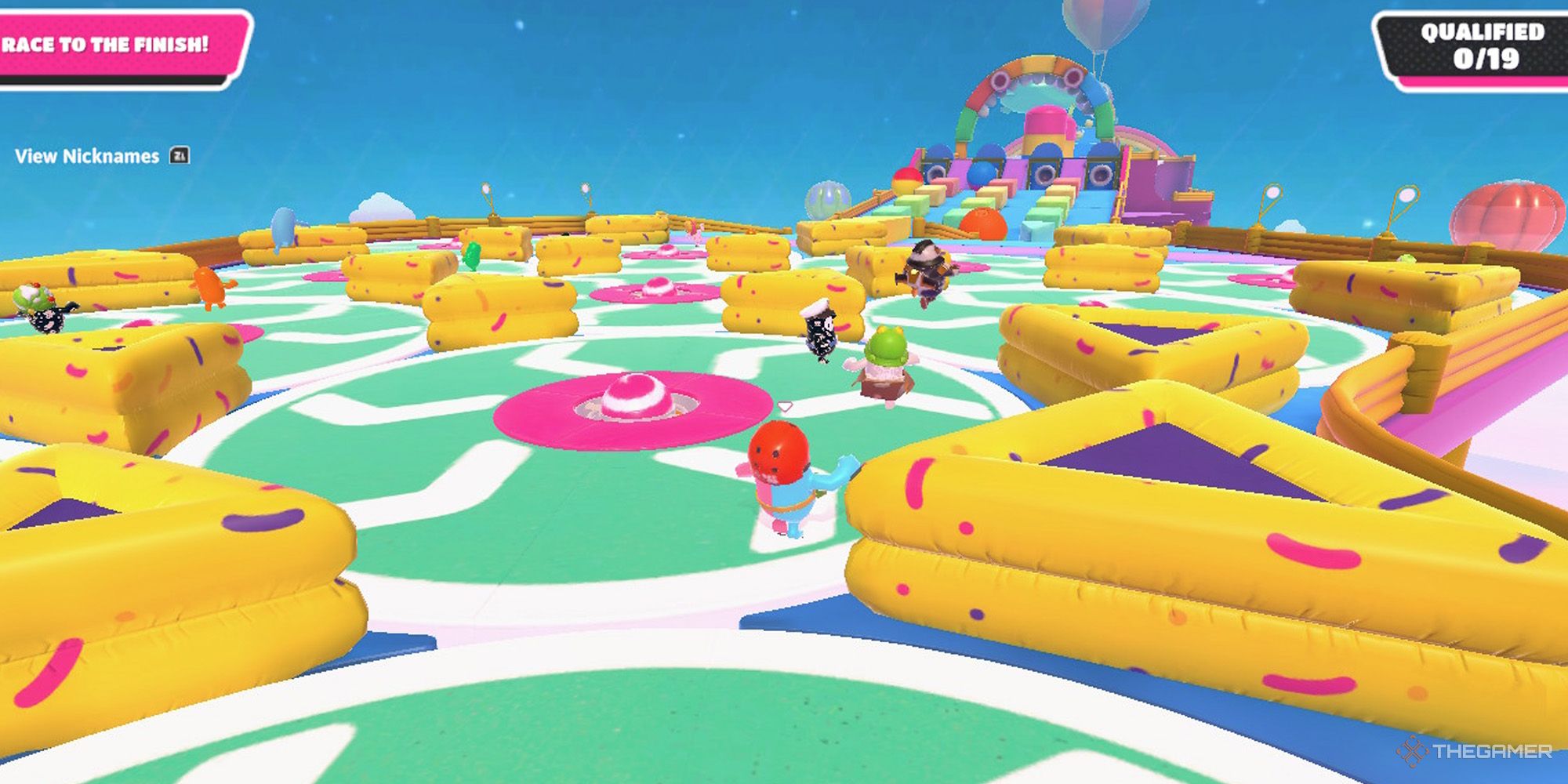 Jelly beans running on a rotating platform in Fall Guys.