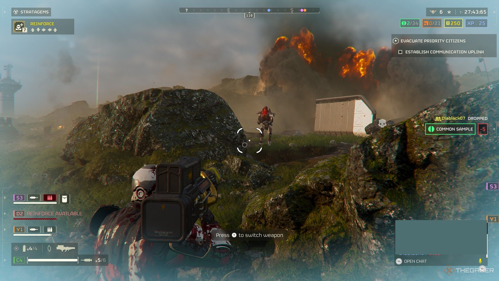 A screenshot from Helldivers 2 showing the player character, having recently used a Stim, aiming a Quasar Cannon in third person at a Automaton. There's a large explosion in the background.