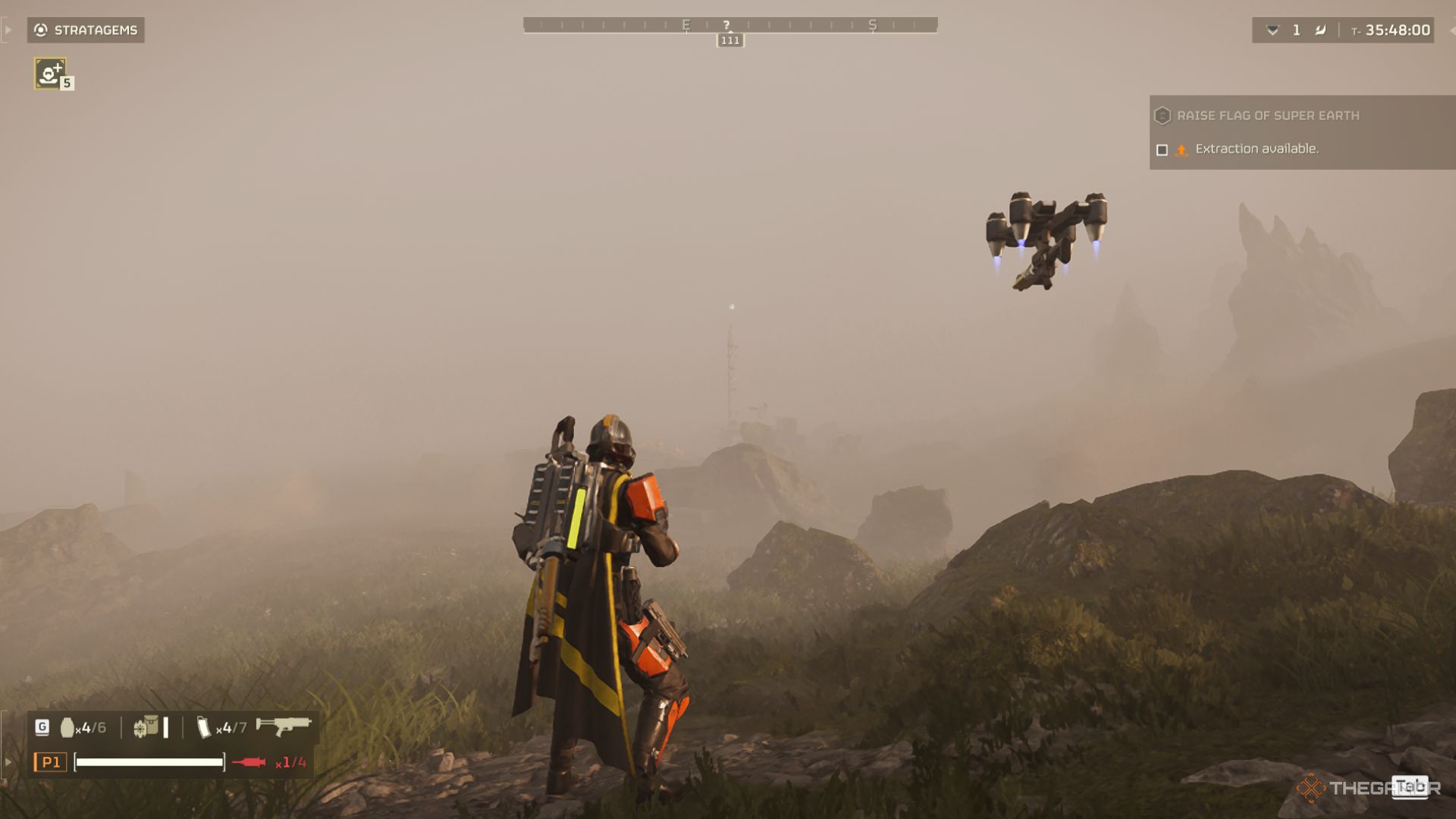 A Helldivers stares out through the fog at a blinking light on a tower.