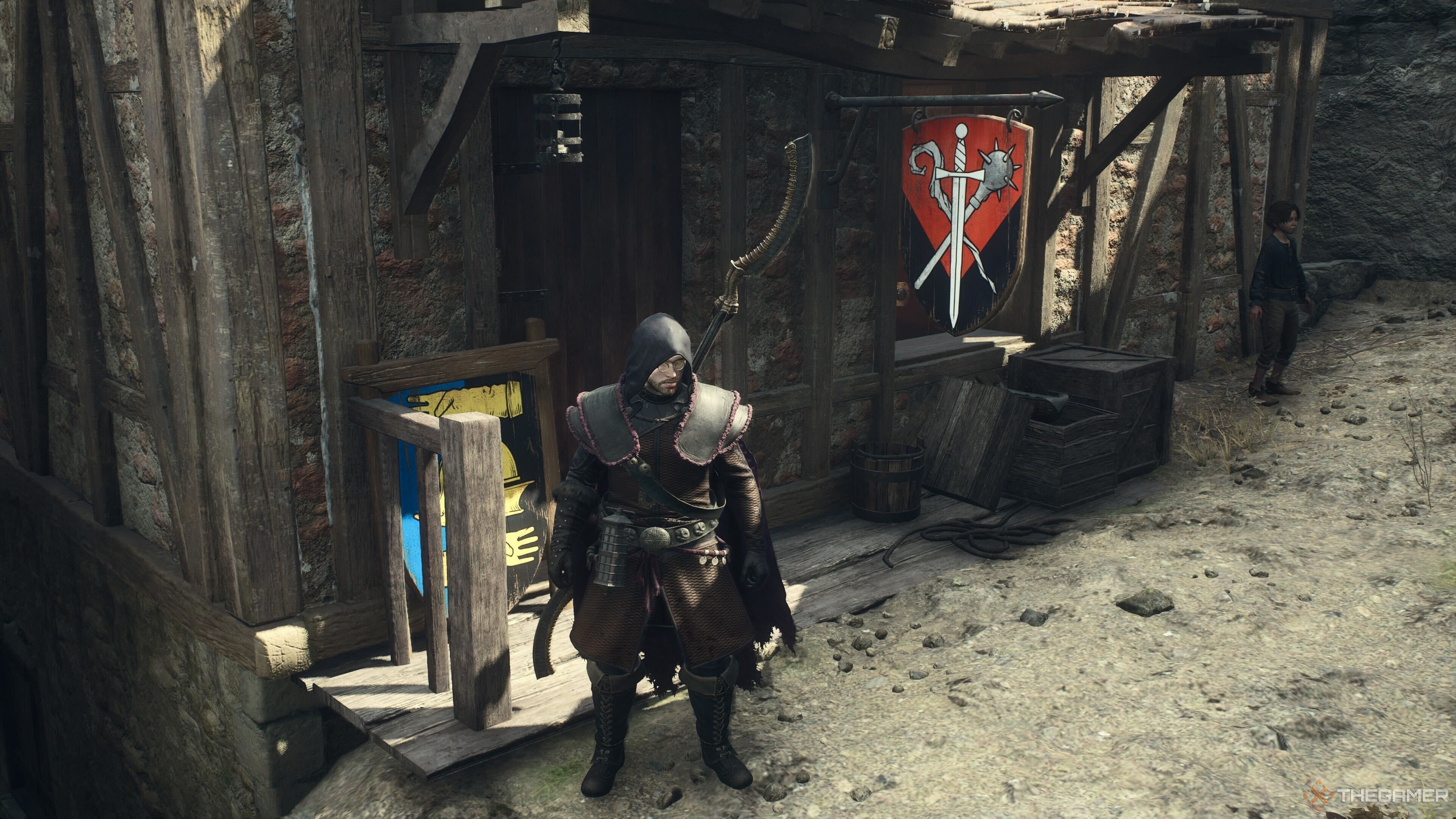 A screenshot from Dragon's Dogma 2 showing the player character standing outside of the weapon and armor shop at the Checkpoint Rest Town on the Vermund-Battahl border.