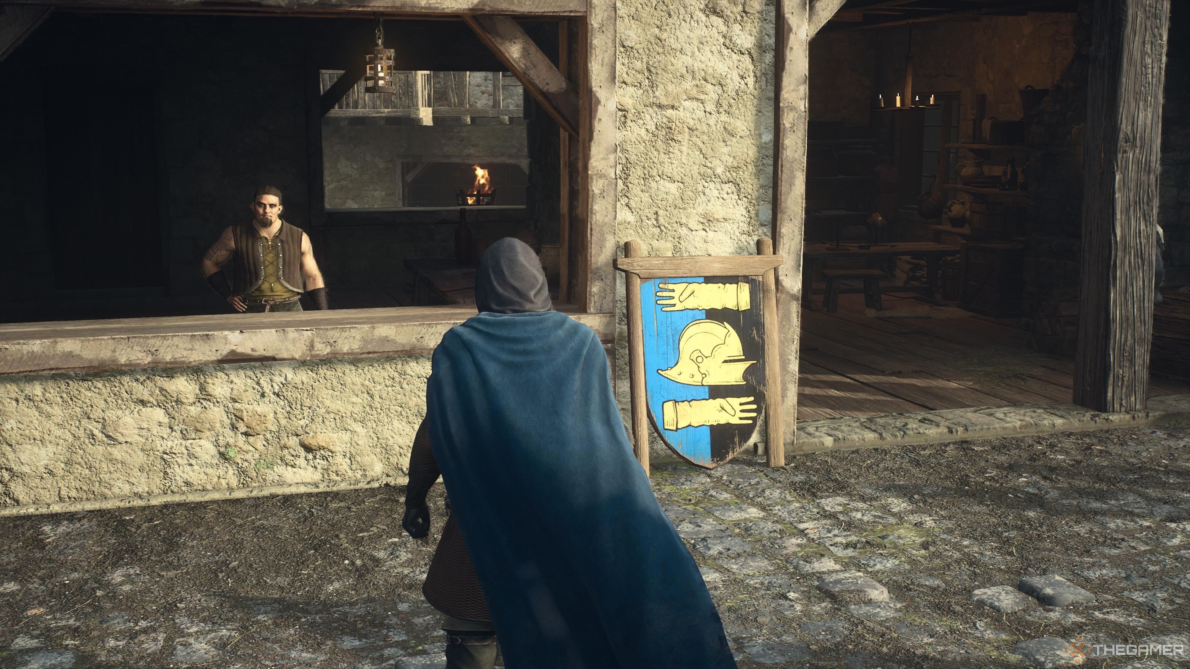 A screenshot from Dragon's Dogma 2 showing the player character standing outside of the armor shop in Vernworth's Merchant section.