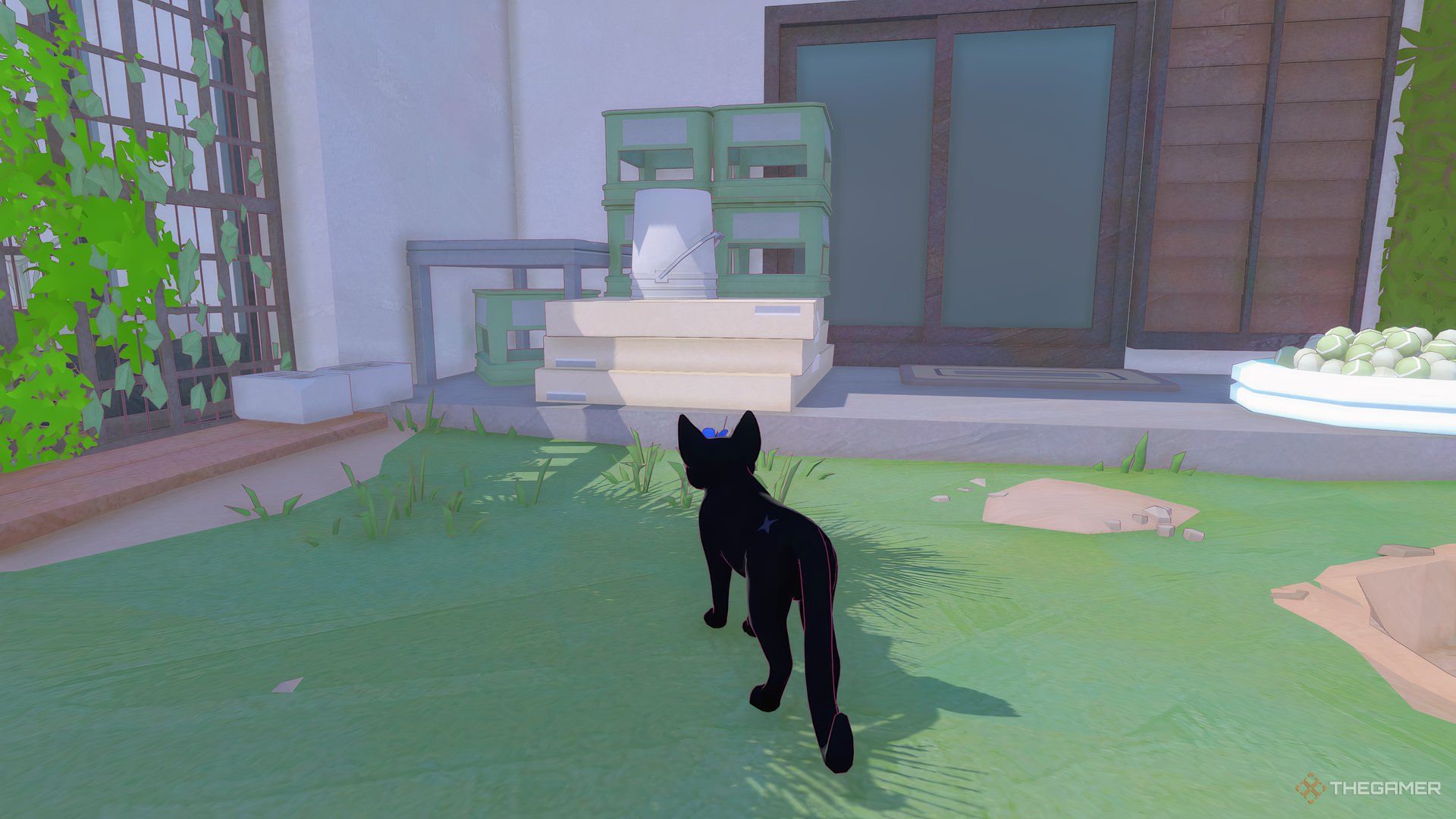 There are green crates, in front of which is a stack of three wide, slender boxes, and on top of the boxes is an upturned bucket in Little Kitty, Big City.