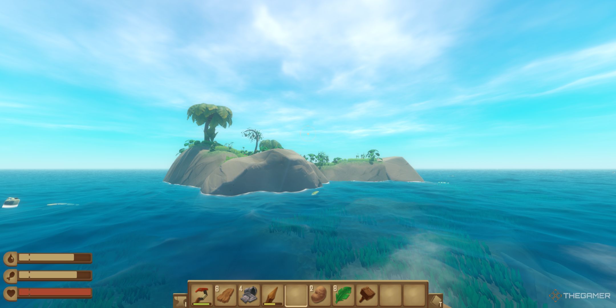 A player floating past a small, rocky, green island with a few tropical trees.