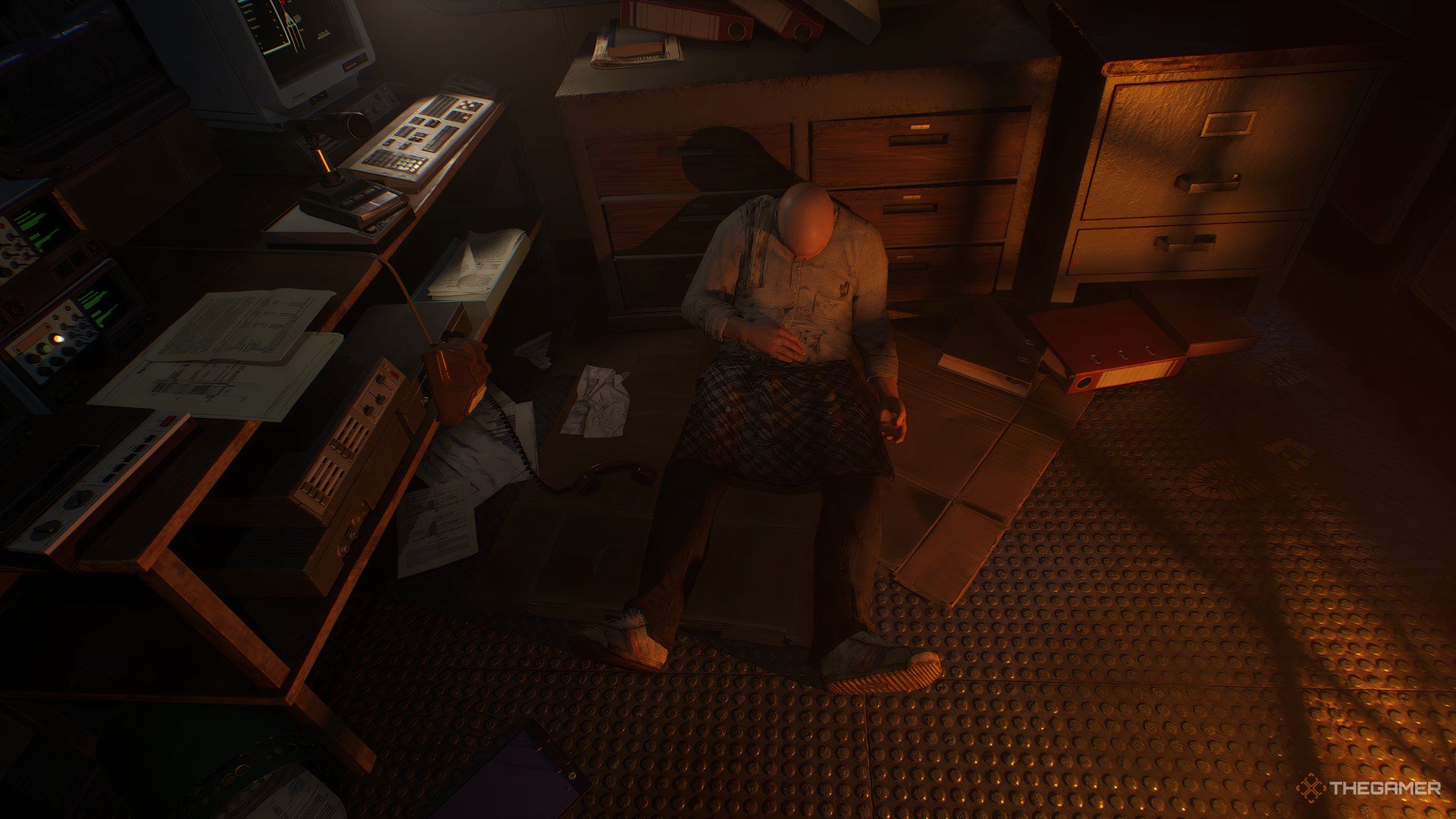 Caz's friend Roy, dead, sitting on the floor of the office in Still Wakes The Deep.