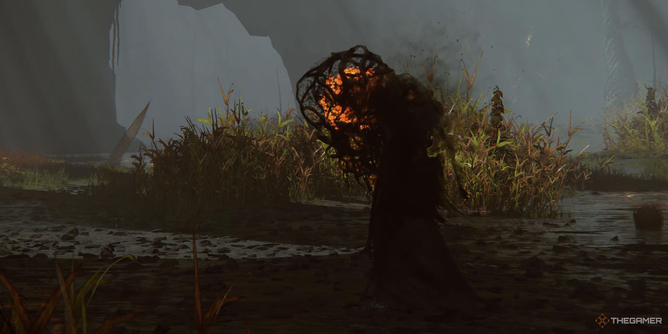 Elden Ring Shadow of the Erdtree strange creature with glowing bulbuous head walking in the muddy woods