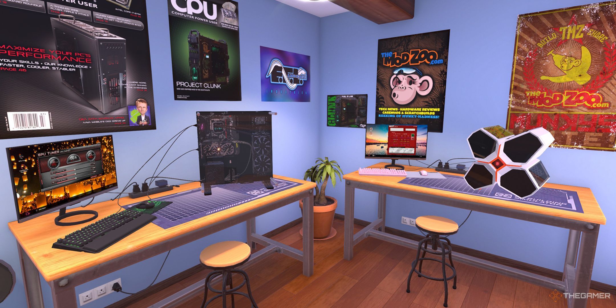 Two light wooden desks with computers and monitors in a blue-walled room.