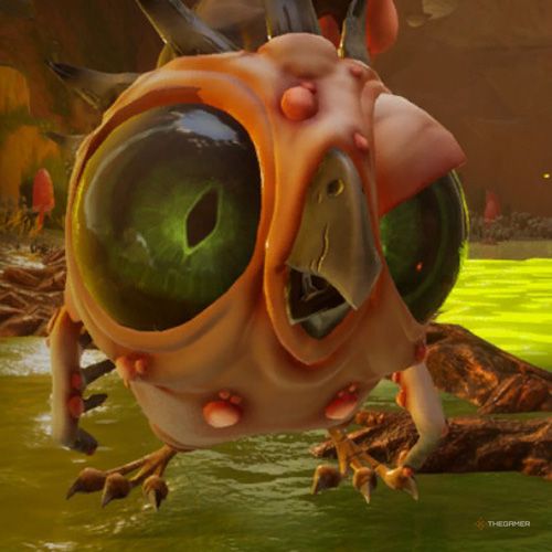 An Infected Pufferbird is standing on the green-colored floor of the cave in Journey To The Savage Planet.