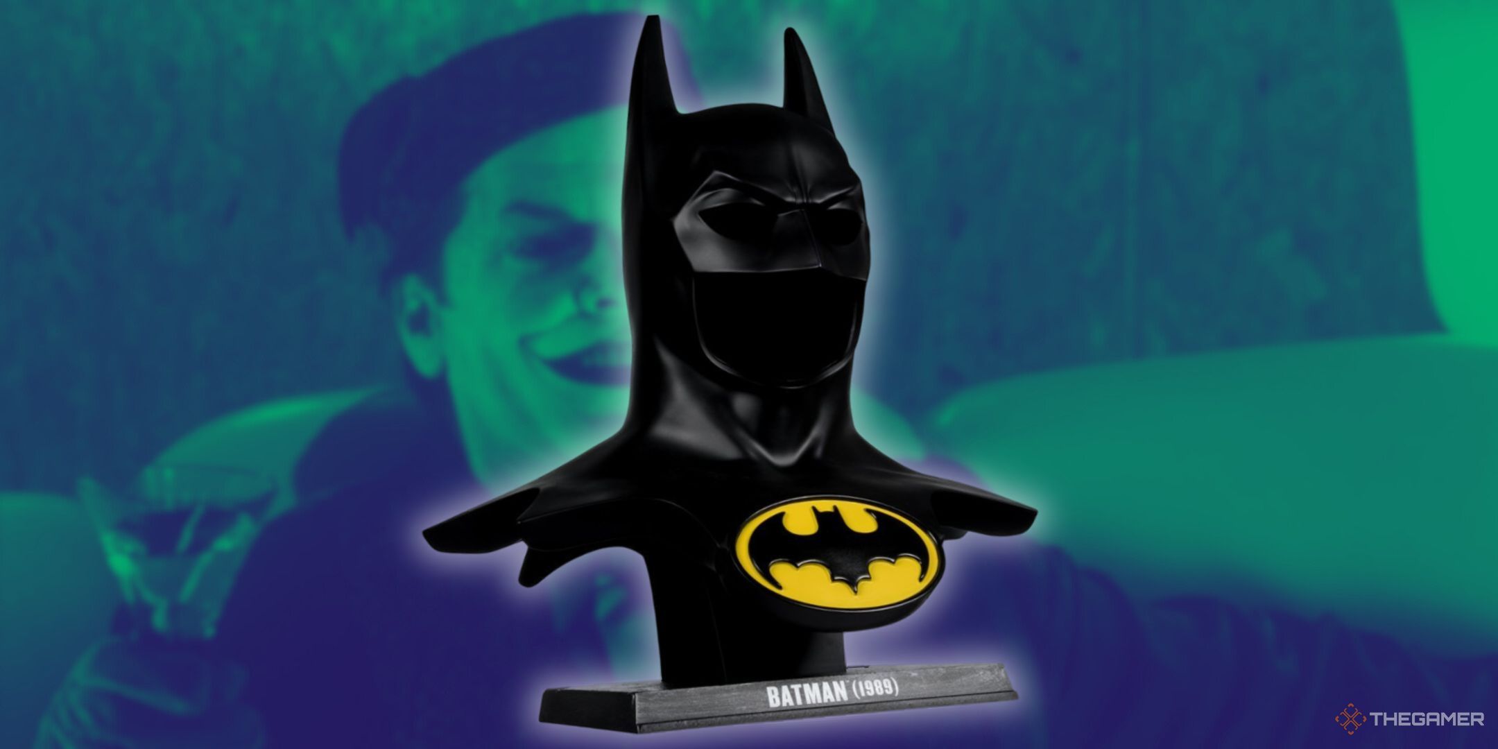 In the background of this featured image is a screenshot of Joker with a green filter over it. In the foreground is the Batman replica cowl.