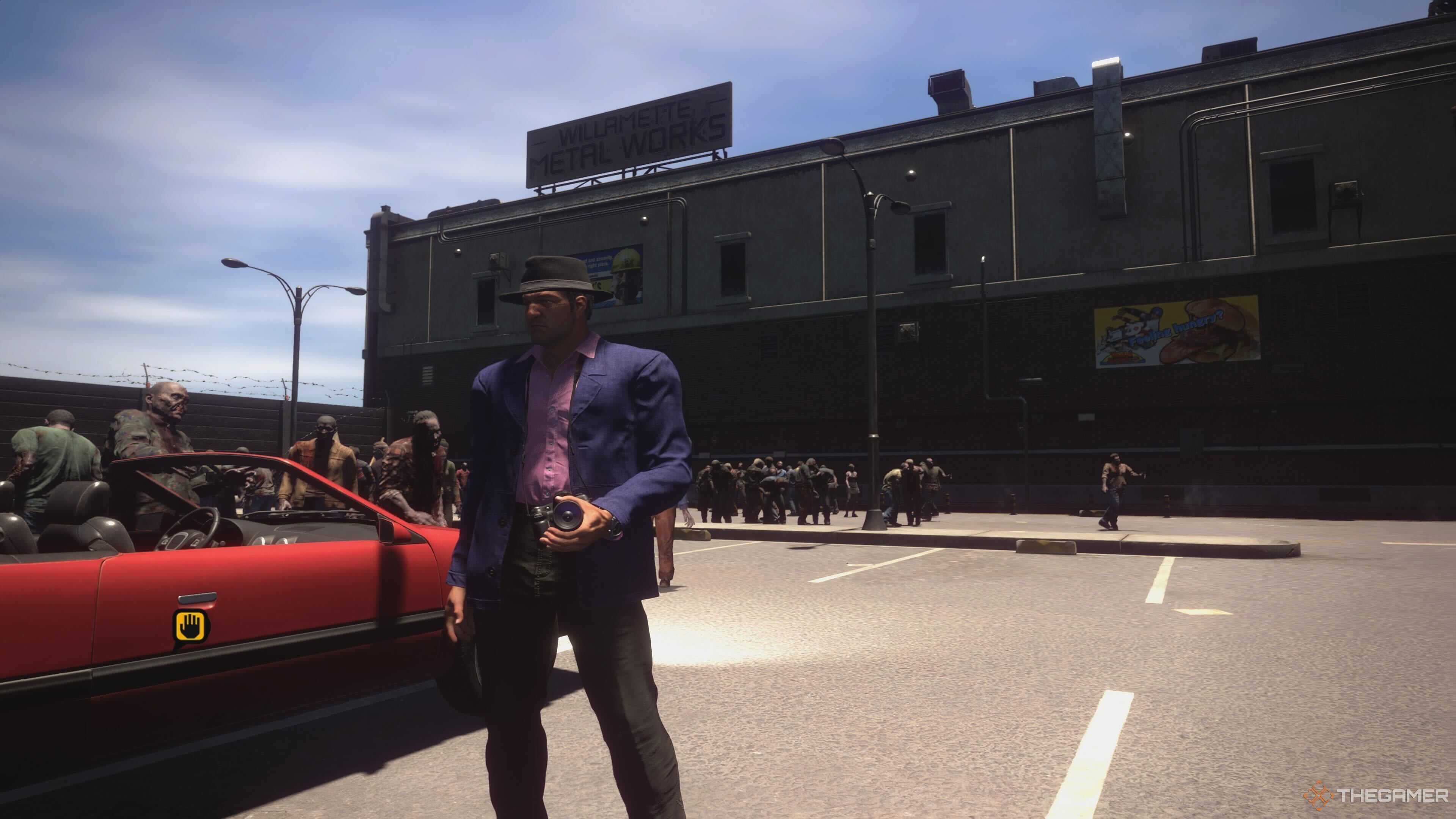 Frank standing next to a red convertible in Dead Rising Deluxe Remaster.