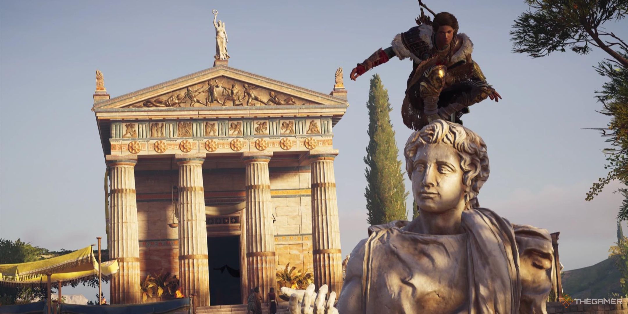 Kassandra perches atop a statue with a temple in the background in Assassin's Creed Odyssey.