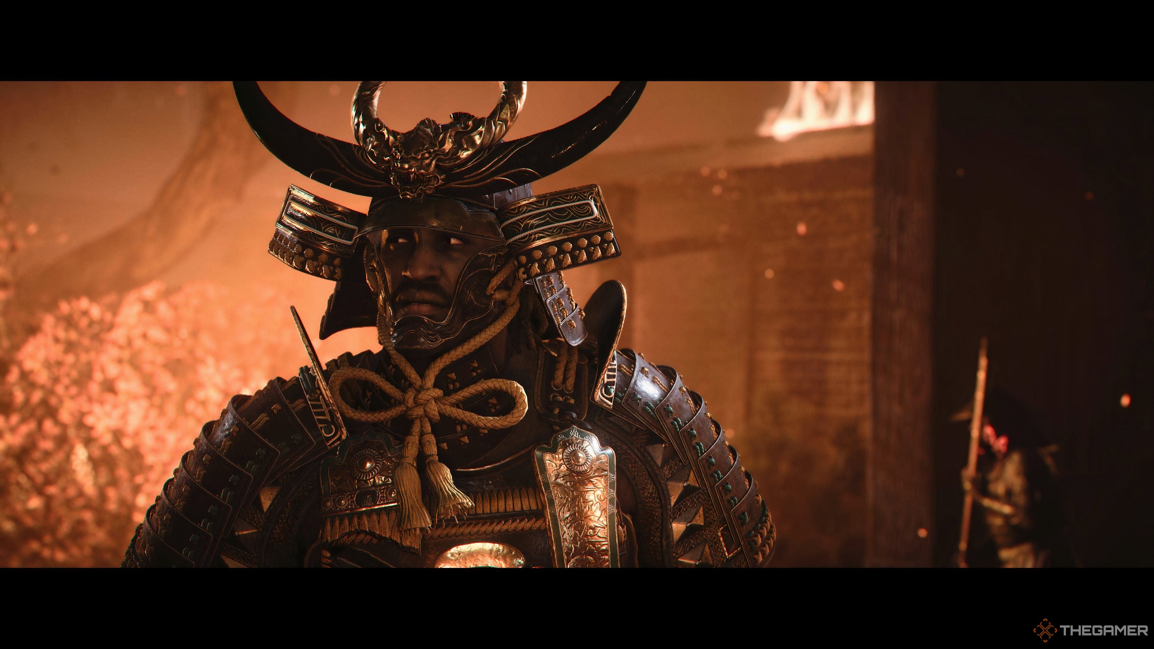 Close-up of Yasuke in Samurai armour standing in a burning temple in Assassin's Creed Shadows.