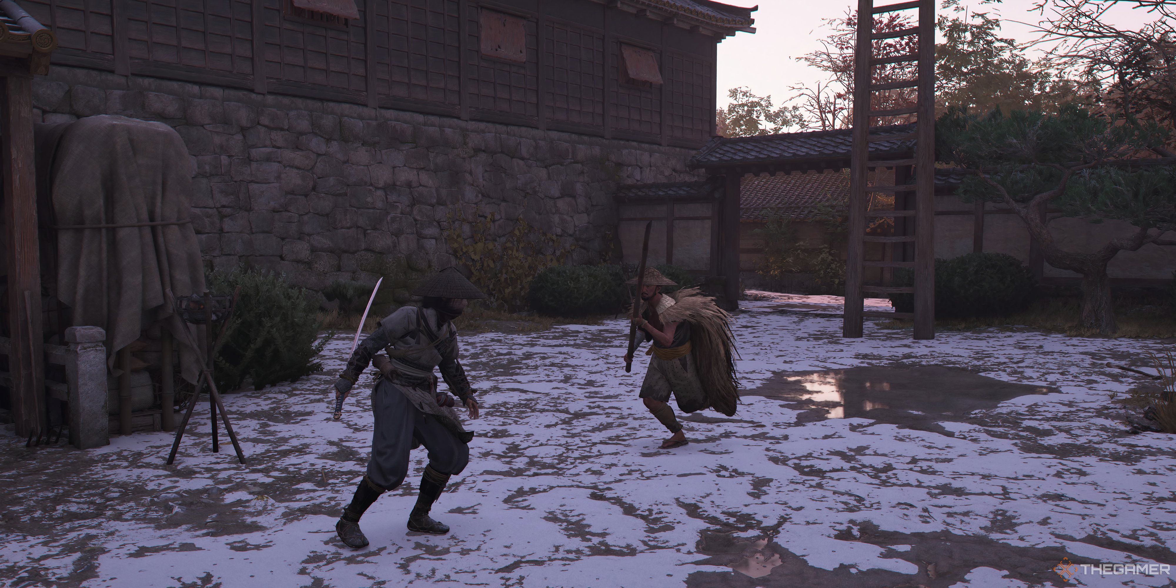 Assassins Creed Shadows Naoe about to get attacked by an enemy. There is snow on the ground. A building is beside her on the left. Behind the enemy is a ladder.