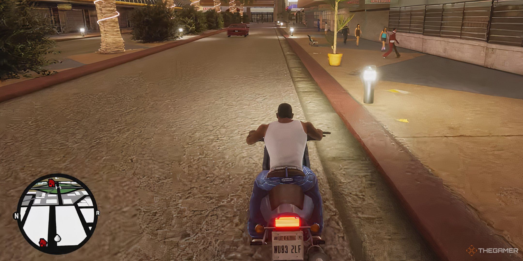 A gameplay screenshot showing CJ riding a motorcycle in Las Venturas in Grand Theft Auto: San Andreas.