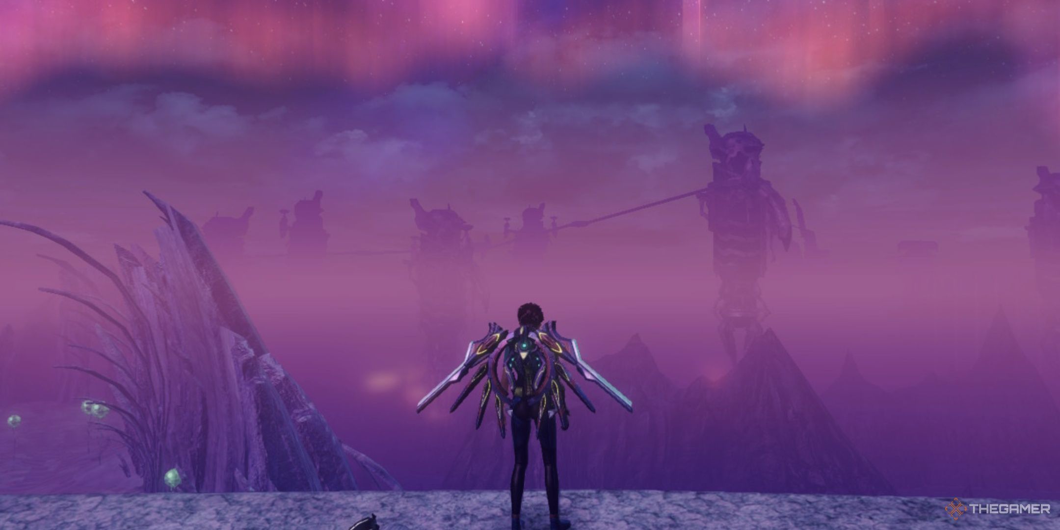 The player standing on a hill in sylvalum while looking towards cauldros with a crimon aurora in the sky in xenoblade chronicles x definitive edition.