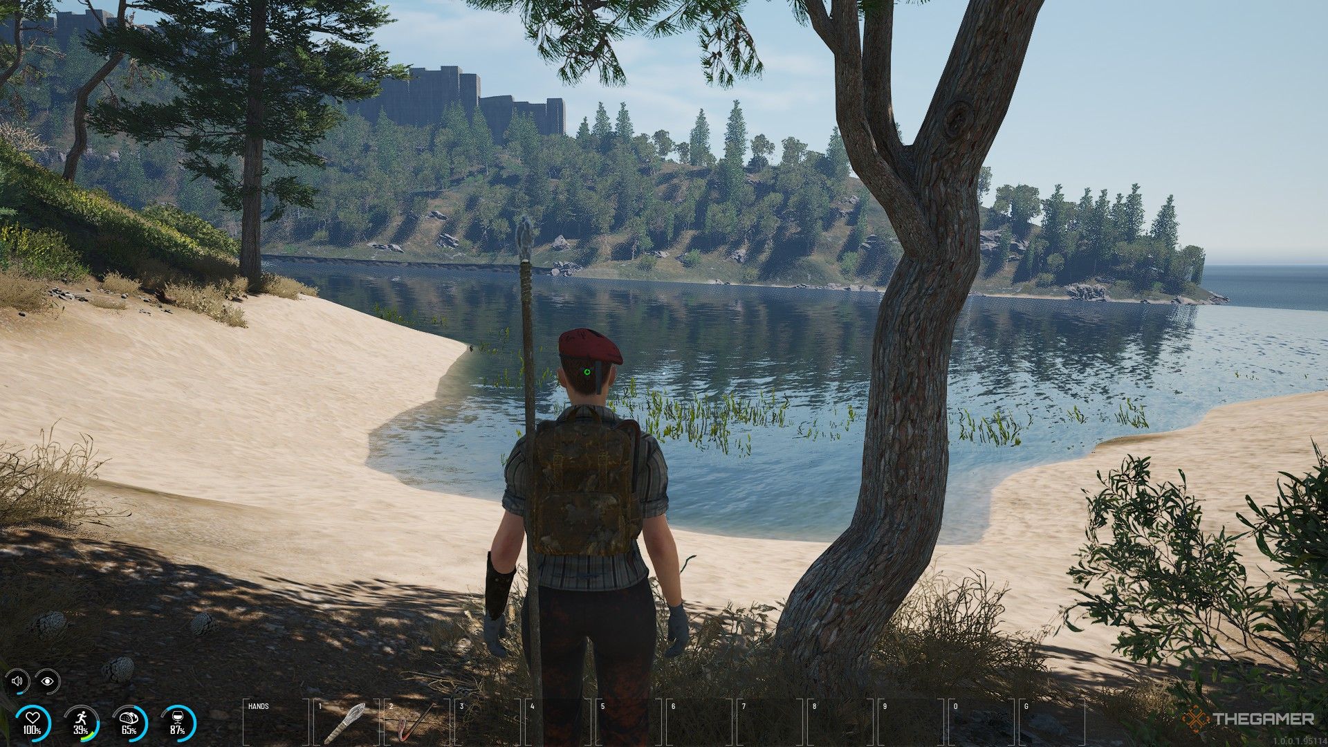 a prisoner in a red beret approaches a riverbank in scum.