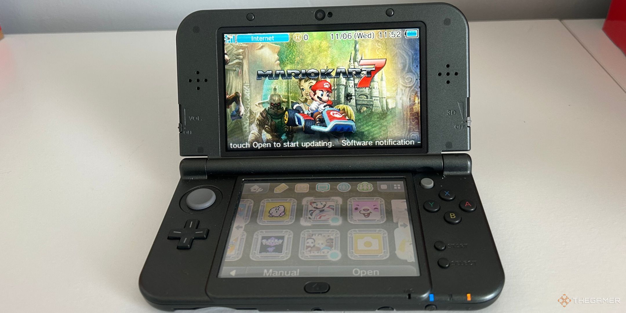A Black 3DS with Mario Kart 7 on the screen.
