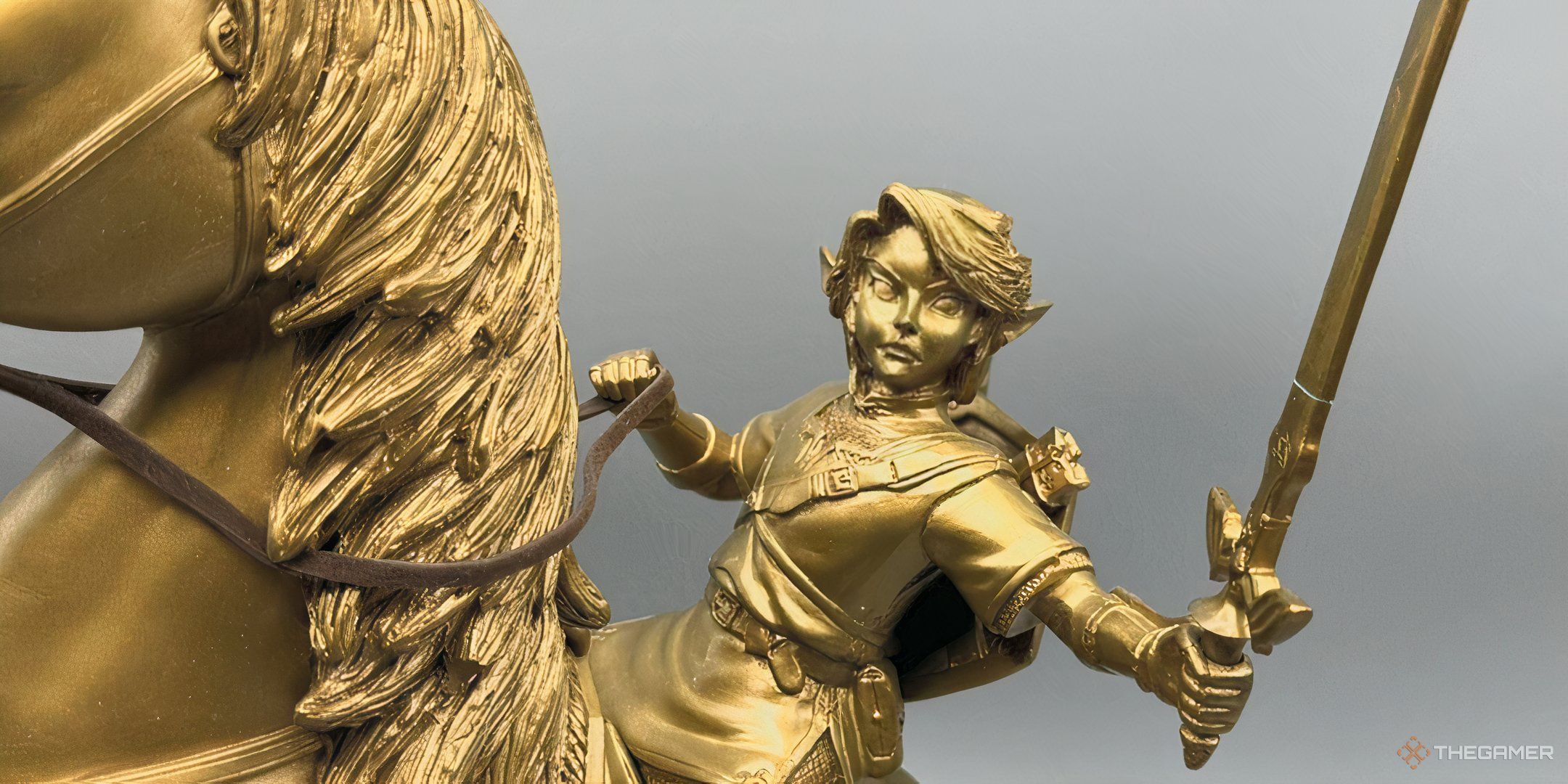 A close-up of the golden Link and Epona statue from Club Nintendo.