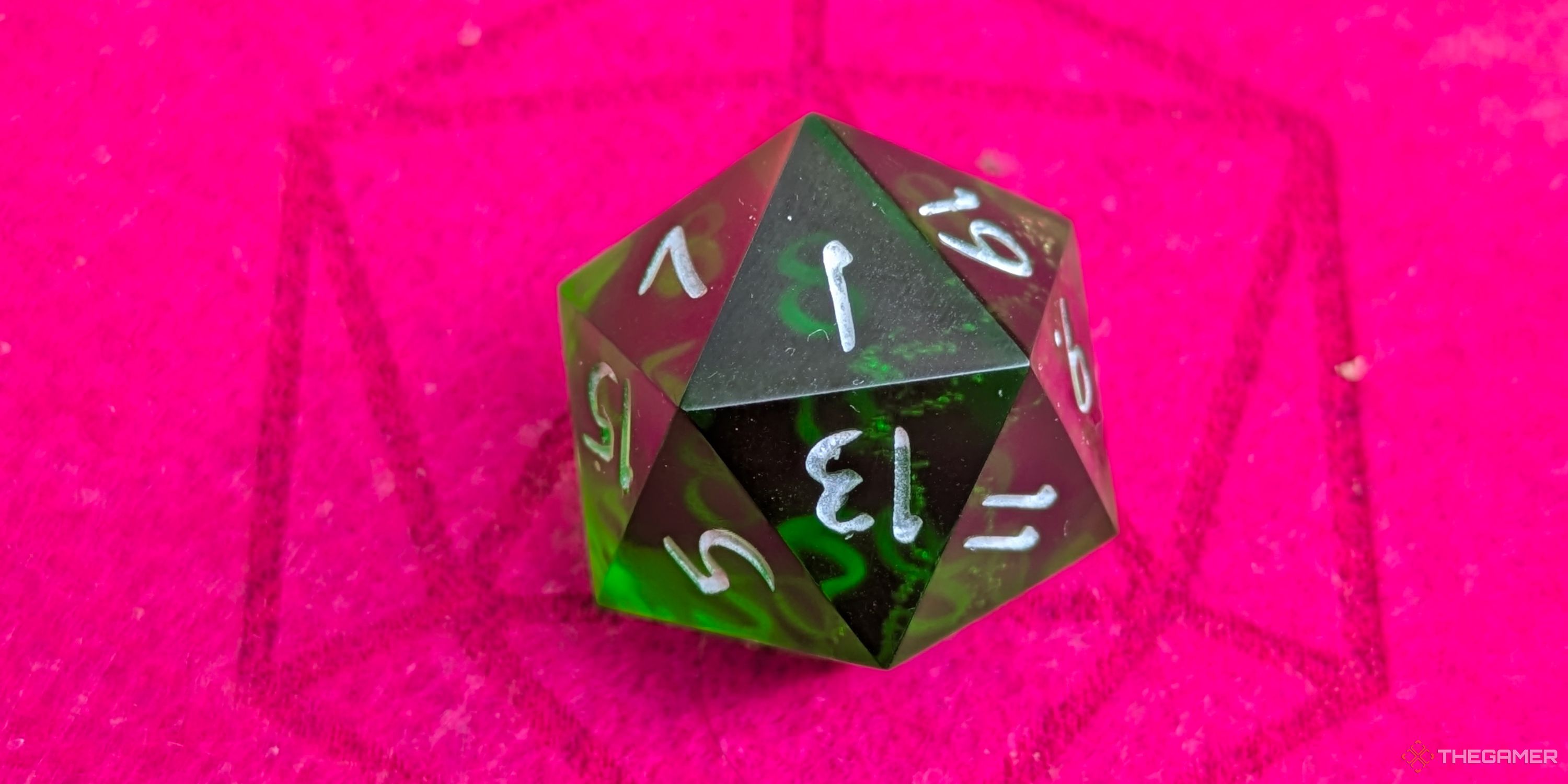 A close up shot of a D20 on red felt, showing a 1.