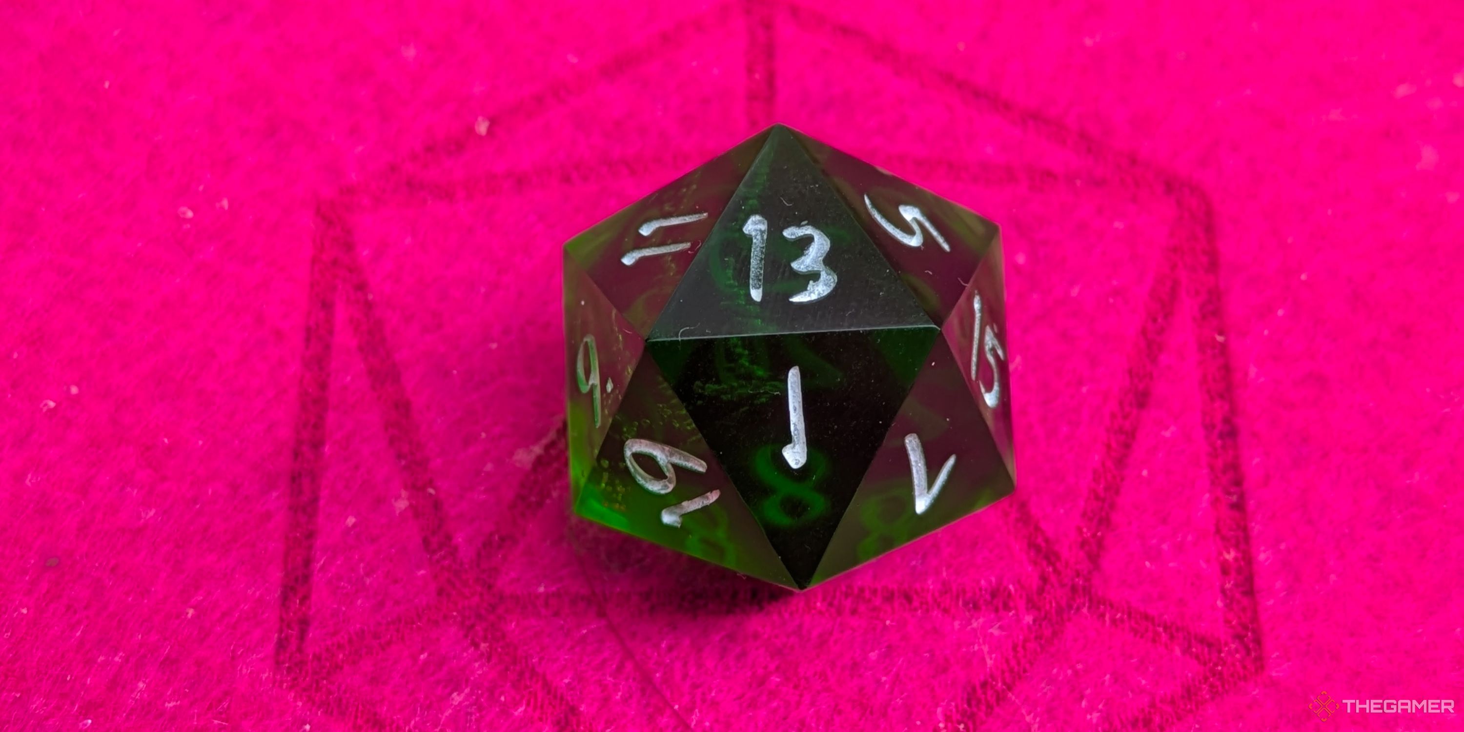 A close up shot of a D20 on red felt, showing a 13.