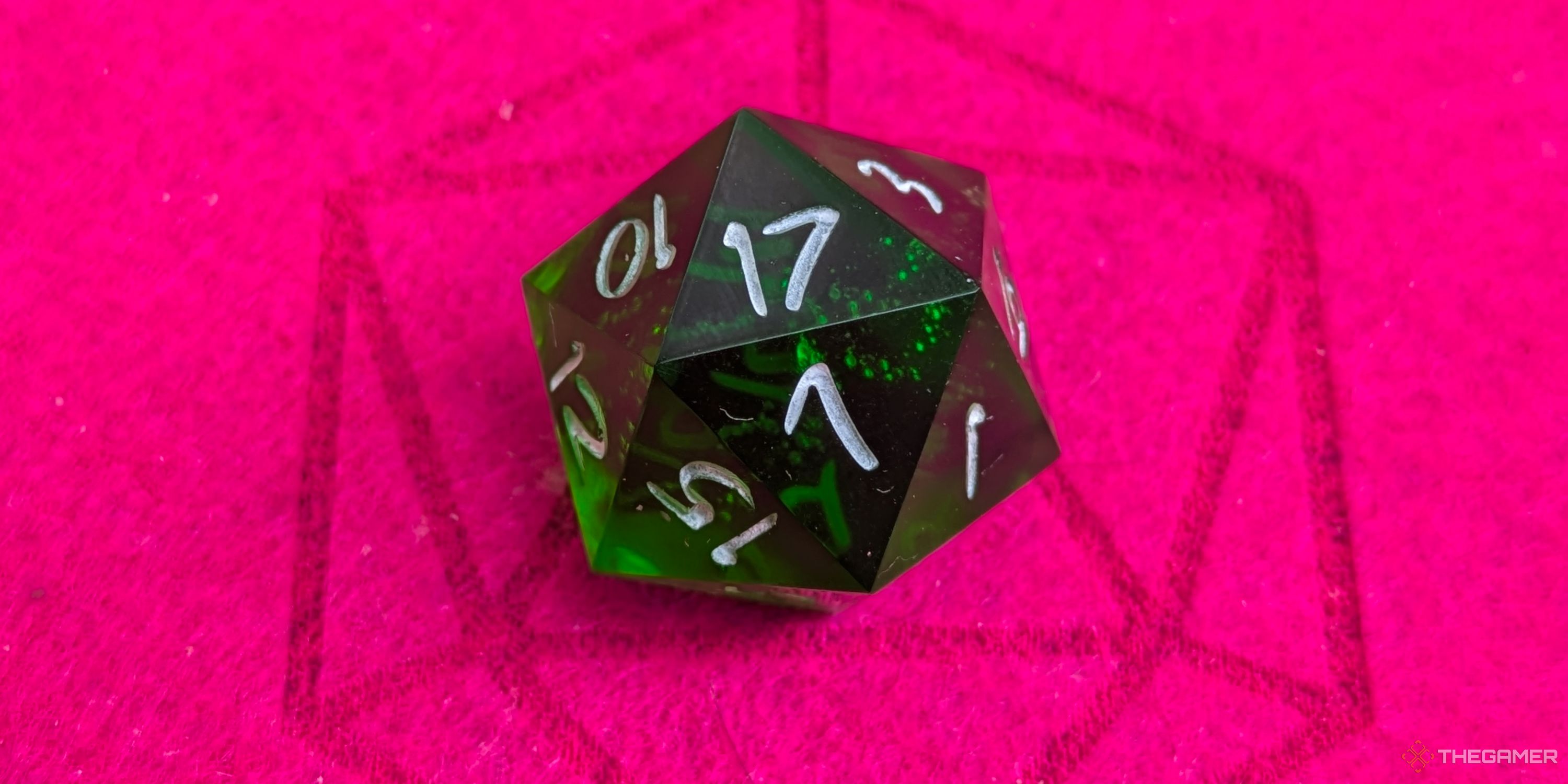 A close up shot of a D20 on red felt, showing a 17.