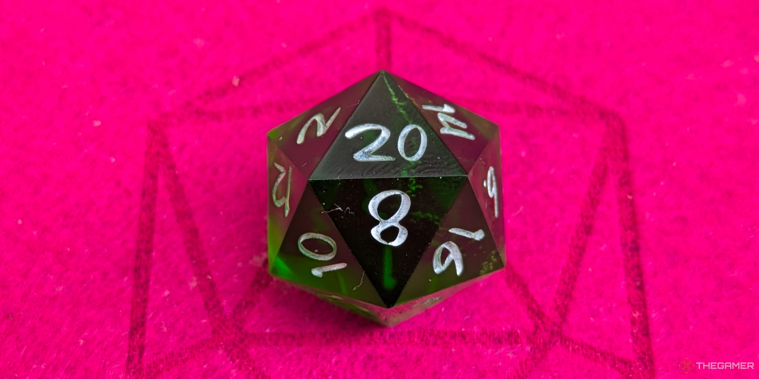 A close up shot of a D20 on red felt, showing a 20.