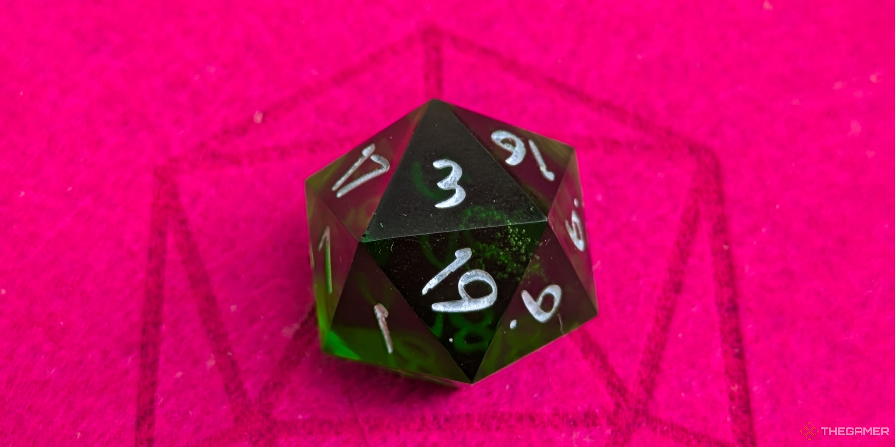 A close up shot of a D20 on red felt, showing a 3.