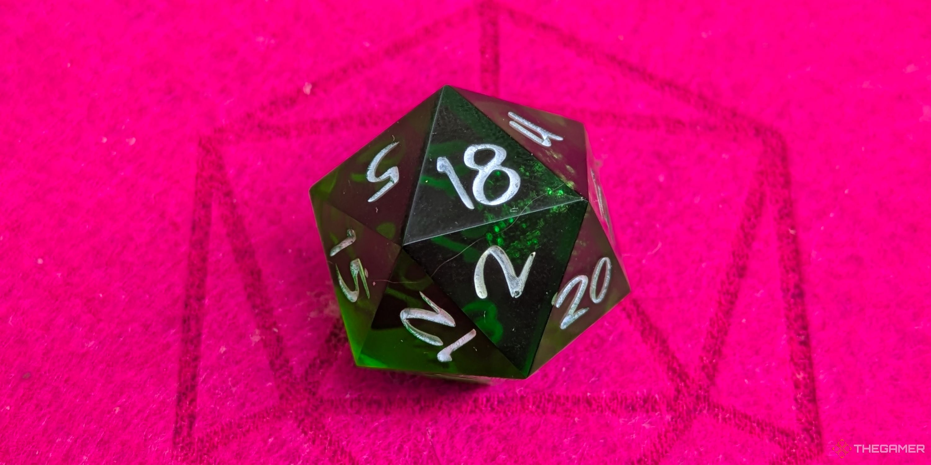 A close up shot of a D20 on red felt, showing an 18.