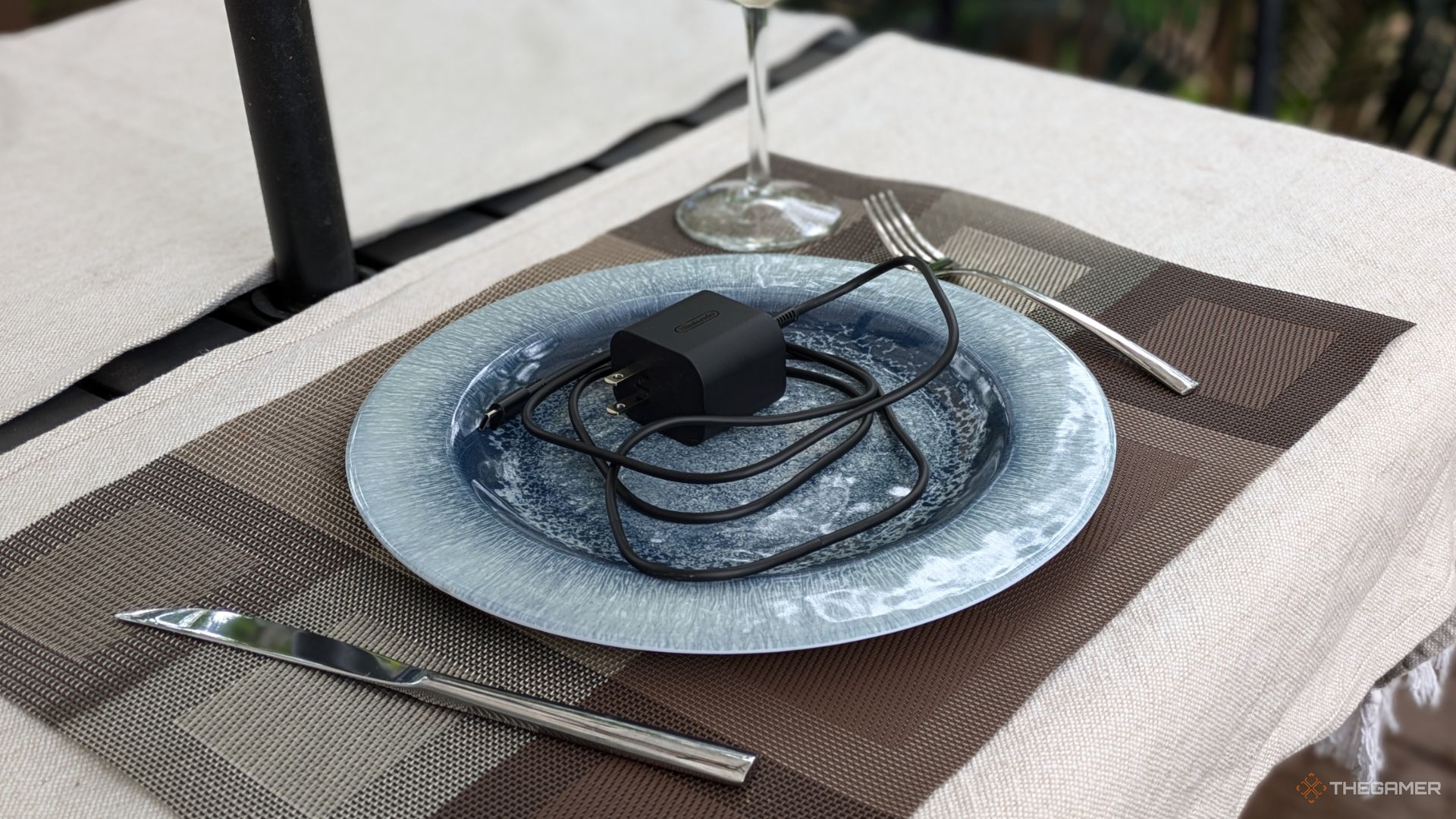 A Nintendo Switch 2 Power Cord On A Plate.