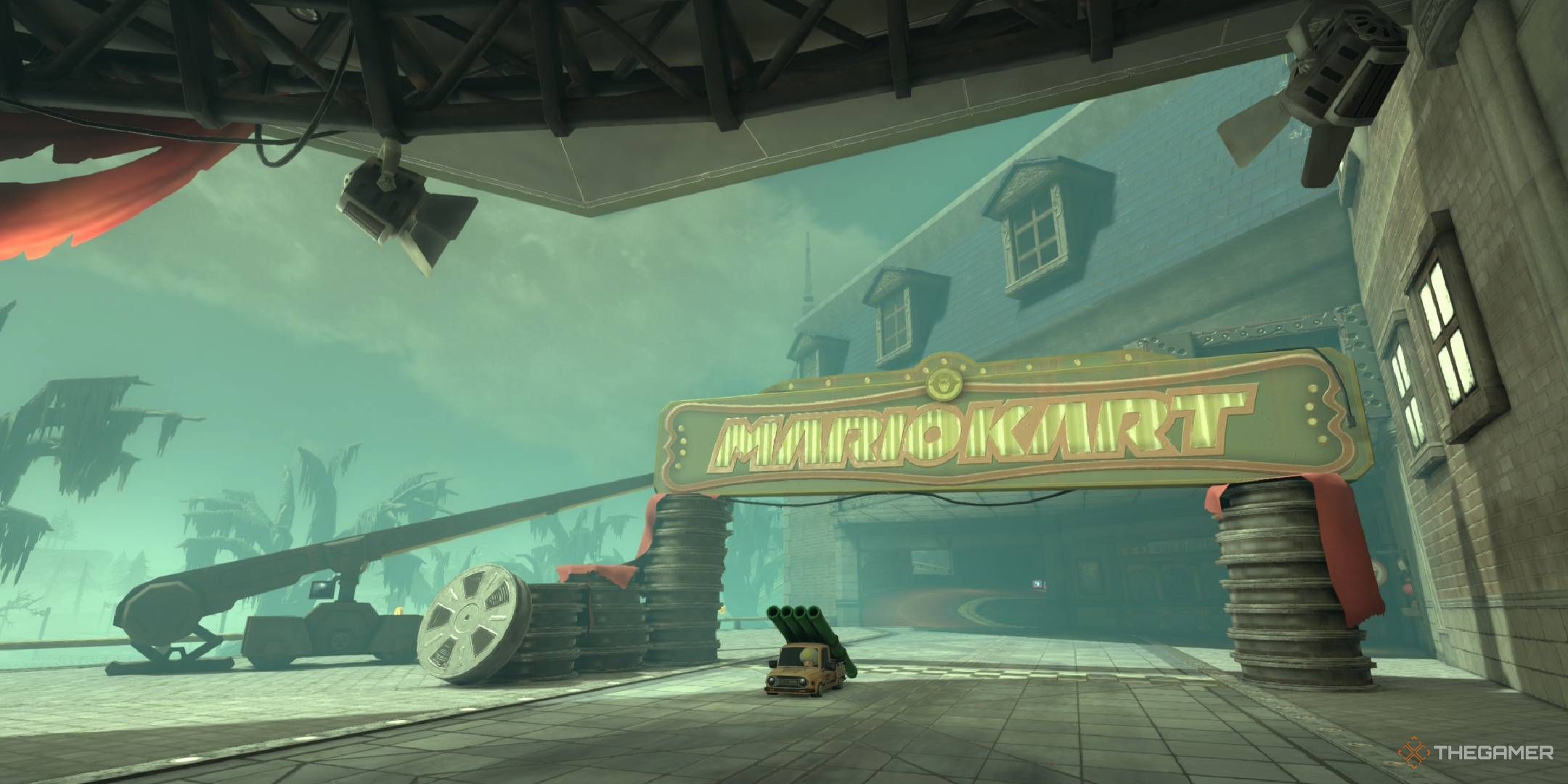Boo Cinema starting line with a spooky atmosphere, reels of old film, and ship wrecks in the background from Mario Kart World.