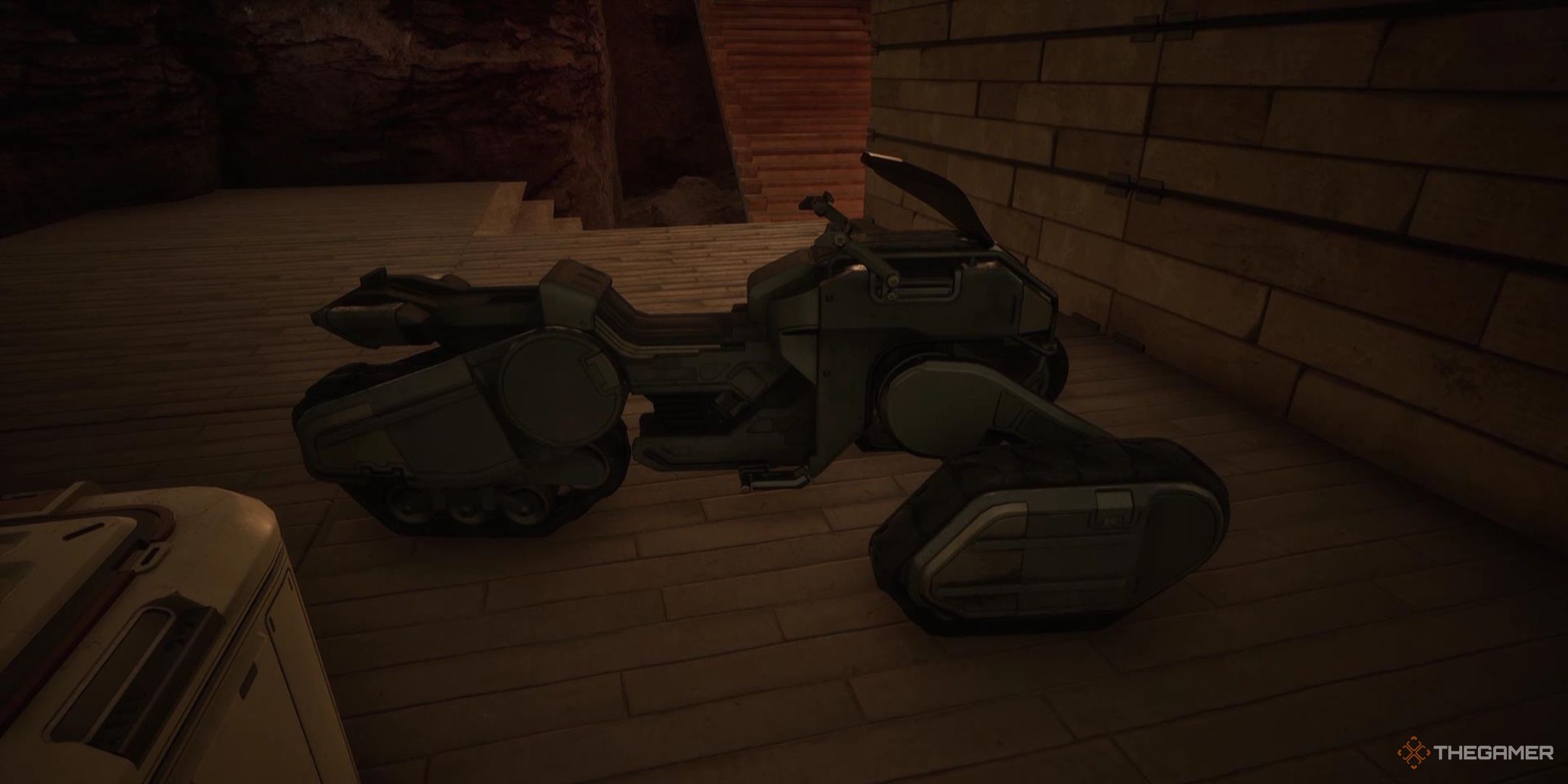 A sandbike sits in a garage in Dune Awakening.