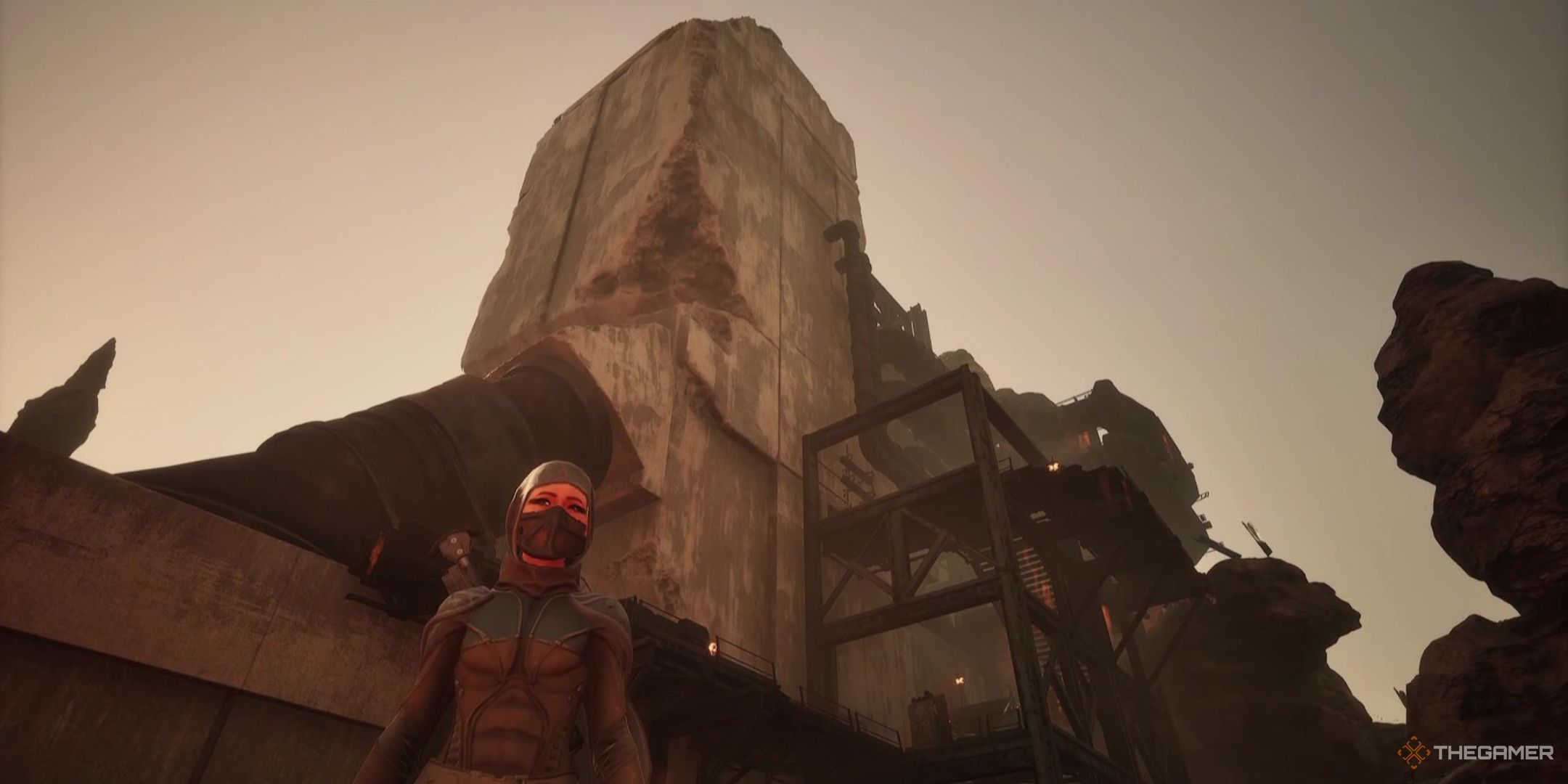 Mel'la Yel'la stands in front of an Ironworks building in Dune Awakening.
