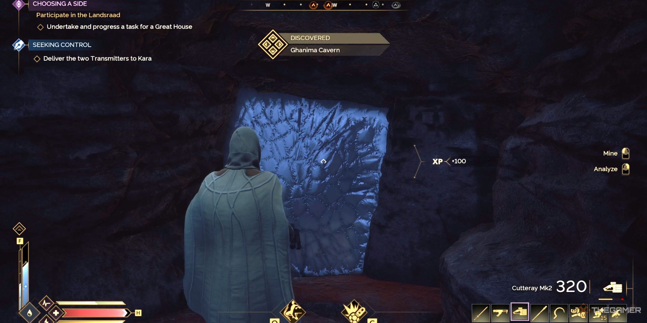 A player character approaches a cavern in Dune: Awakening. 