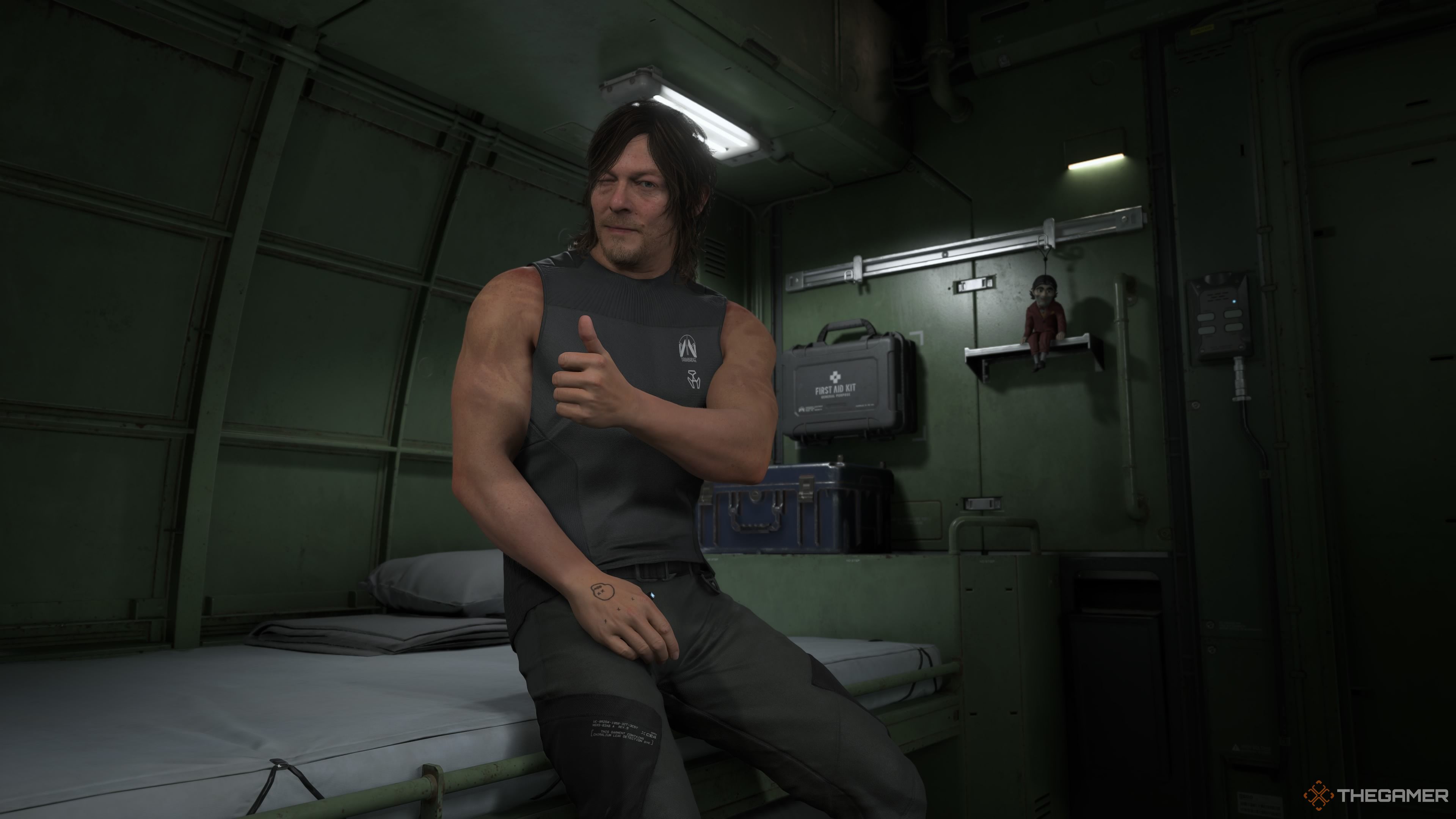 Sam gives the player a thumbs up in his private room in Death Stranding 2. 