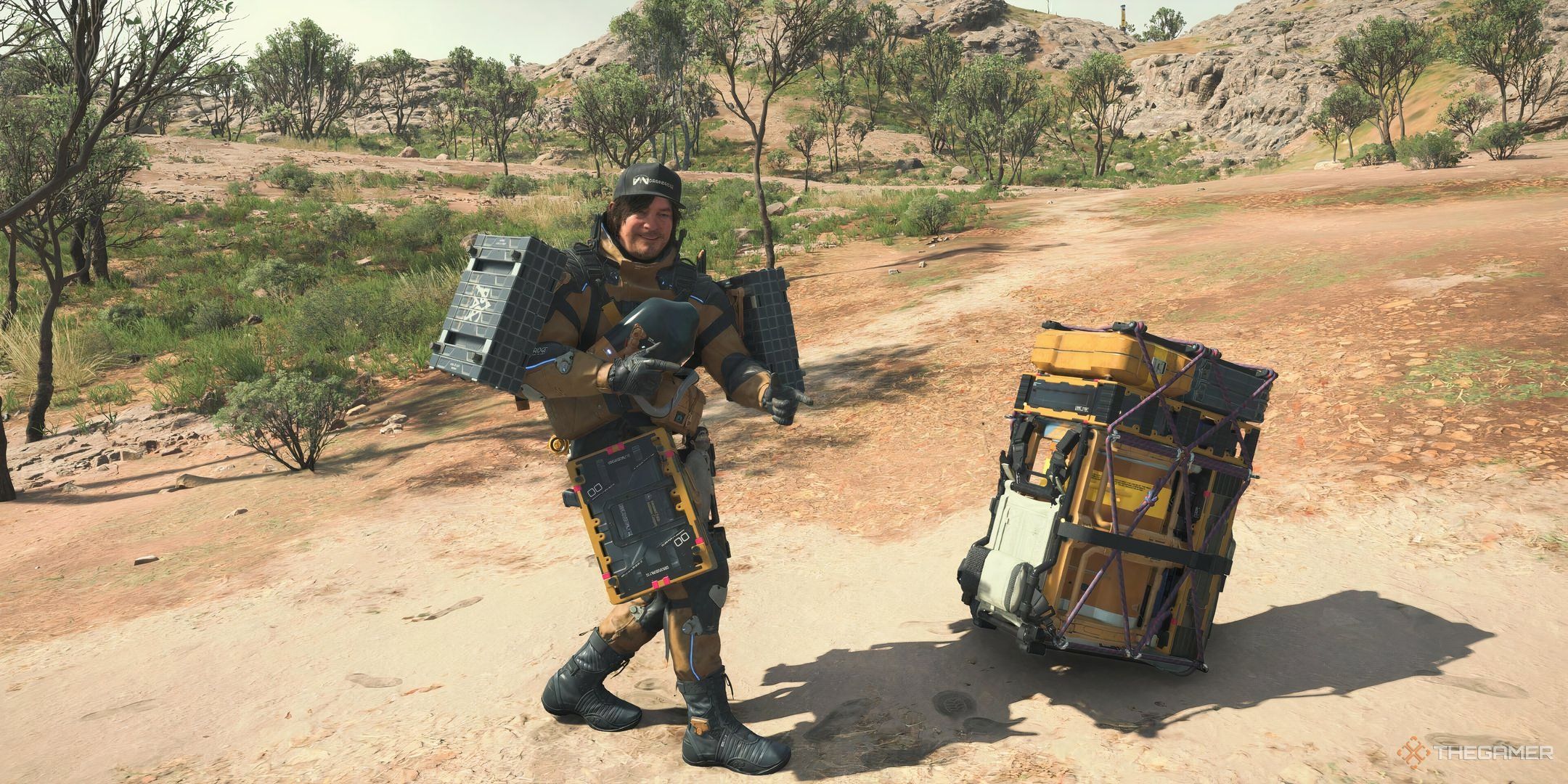 Sam standing next to some binded cargo in Death Stranding 2.