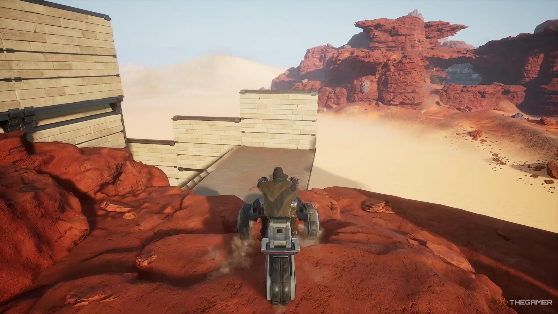 Driving a sandbike into a garage in Dune Awakening.