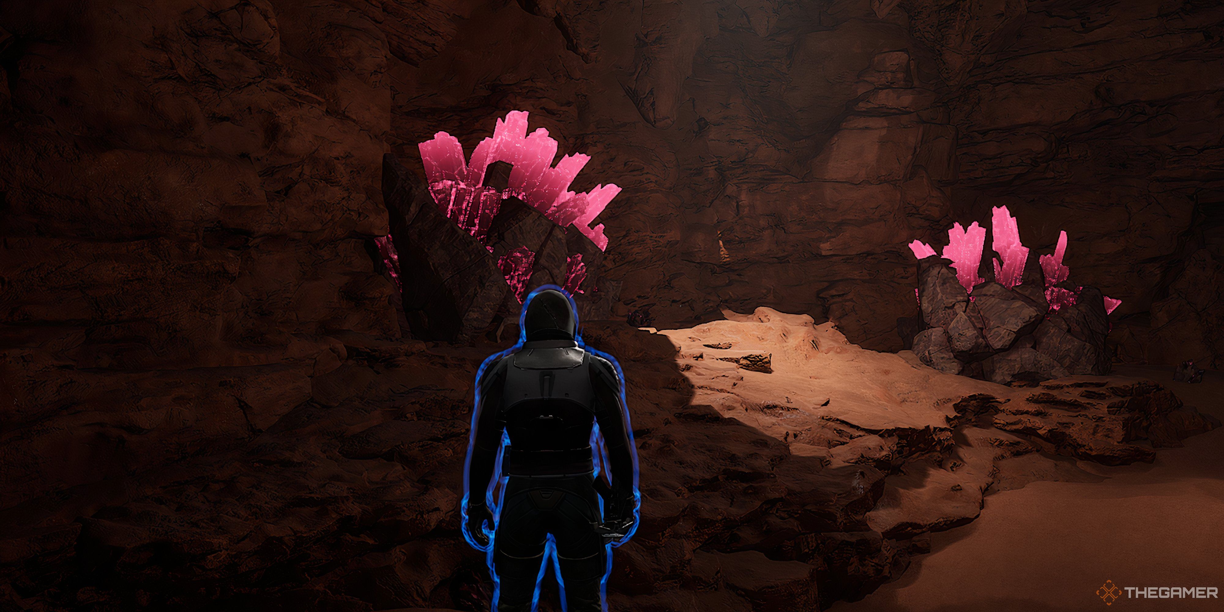 Player looking at two Erythrite Crytal rock piles in Dune: Awakening. The character is also covered in a blue shield.