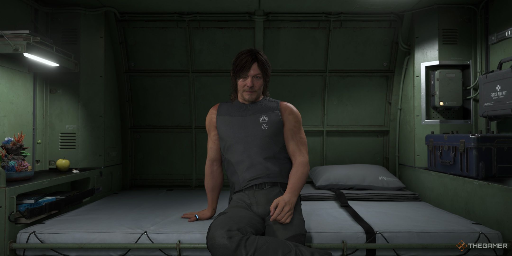 Sam does a seductive pose while sat on his bed in a private room in Death Stranding 2. 
