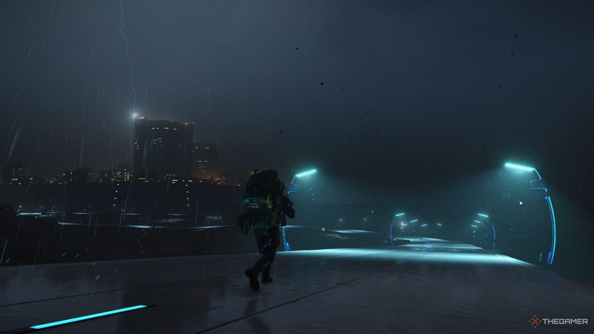 Sam walks along a recently paved road during a storm in Death Stranding 2. 