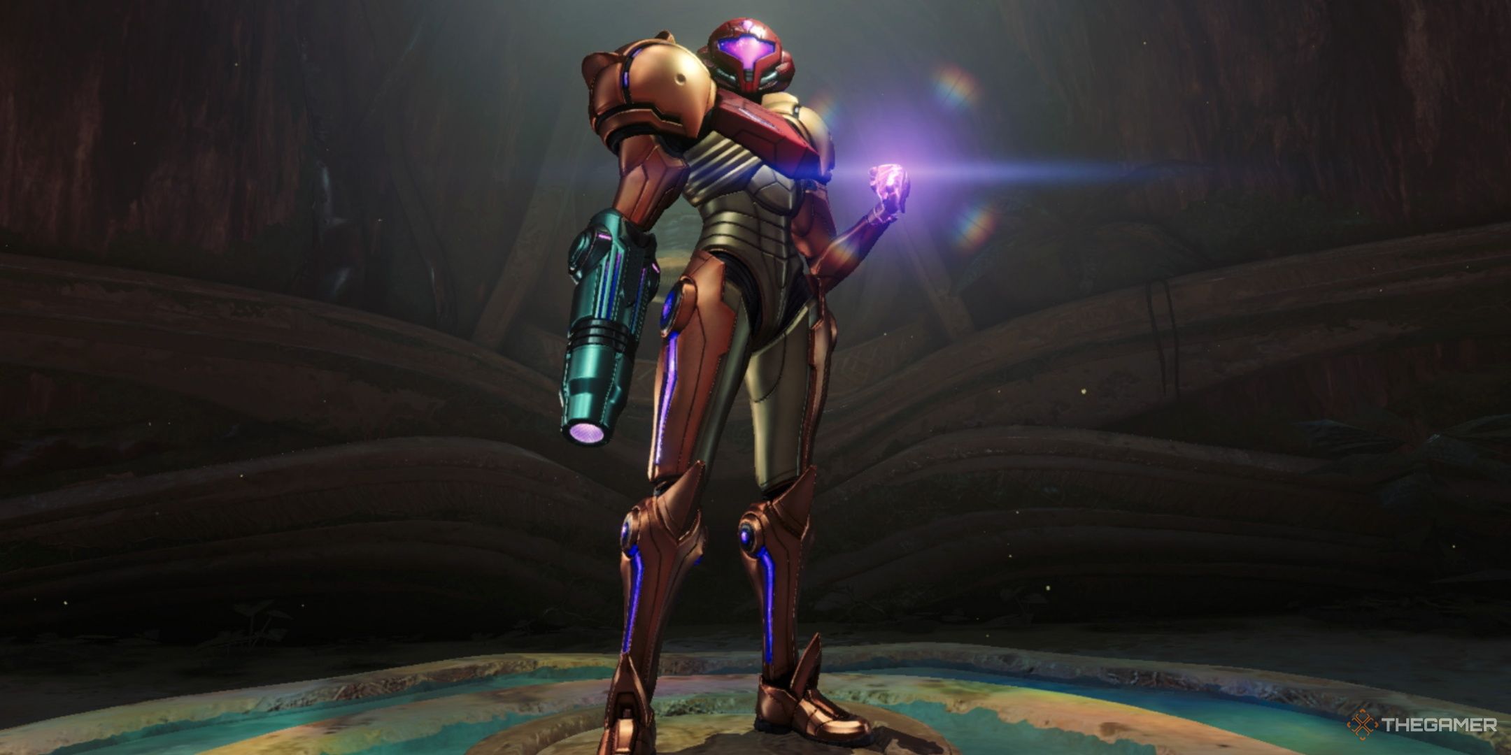 Samus Aran stands in the middle of the screen holding a power-up in Metroid Prime 4: Beyond. 