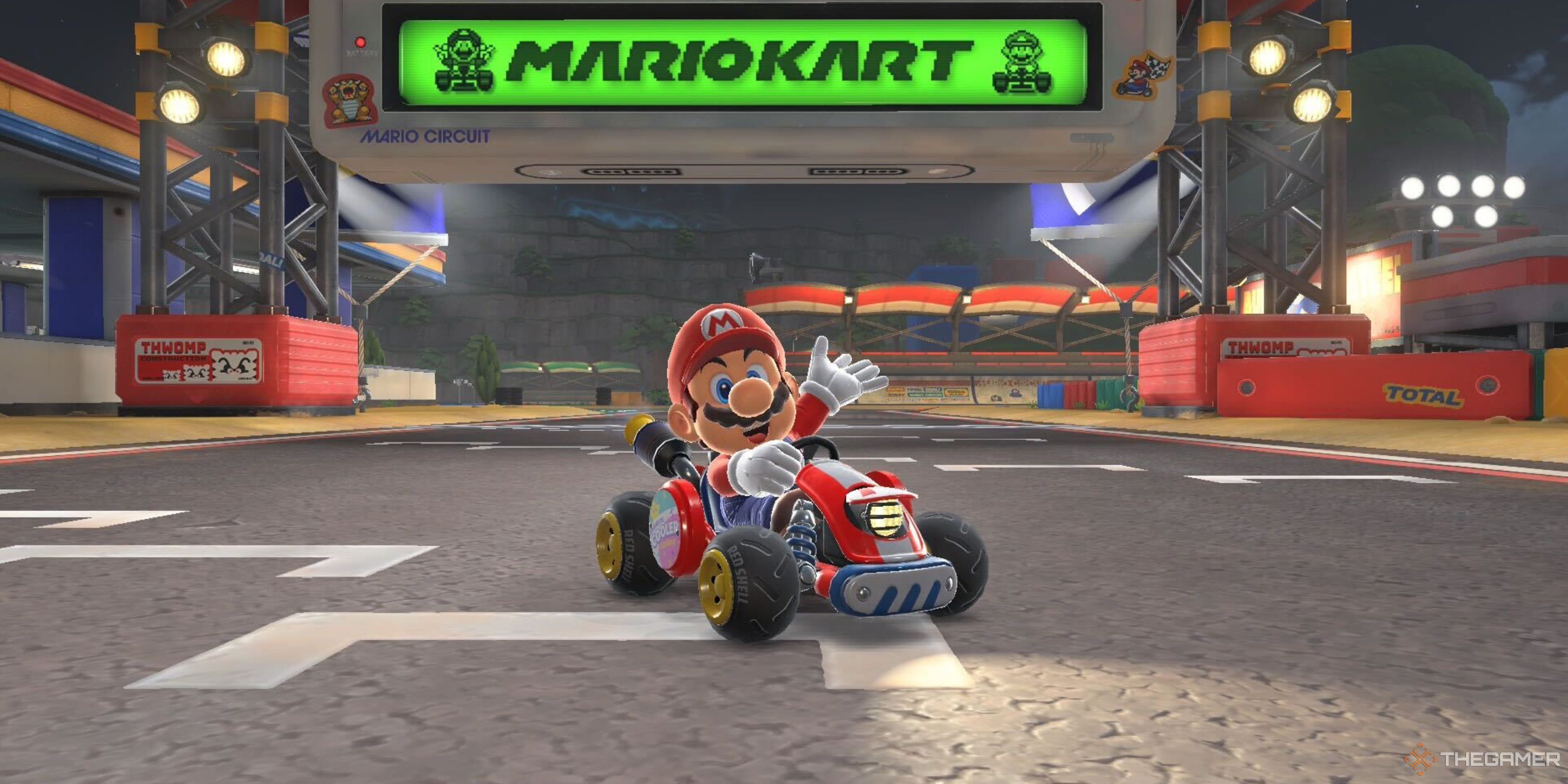 mario kart posing in front of the finish line in mario kart world.