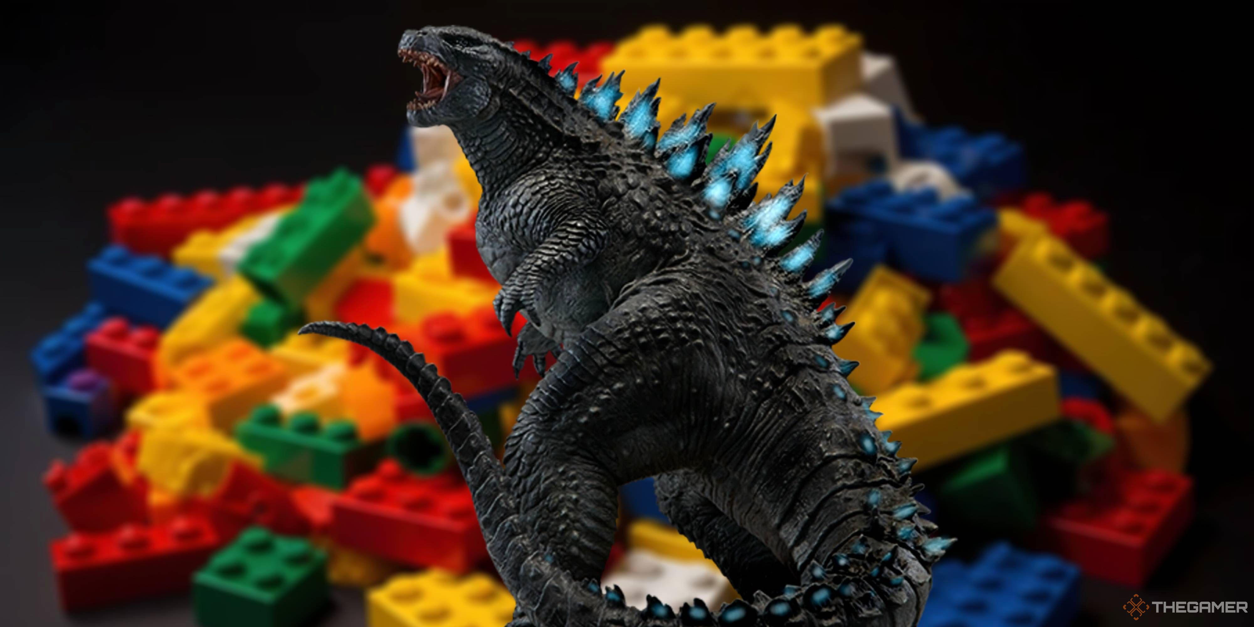 godzilla in front of a blurry pile of lego bricks.