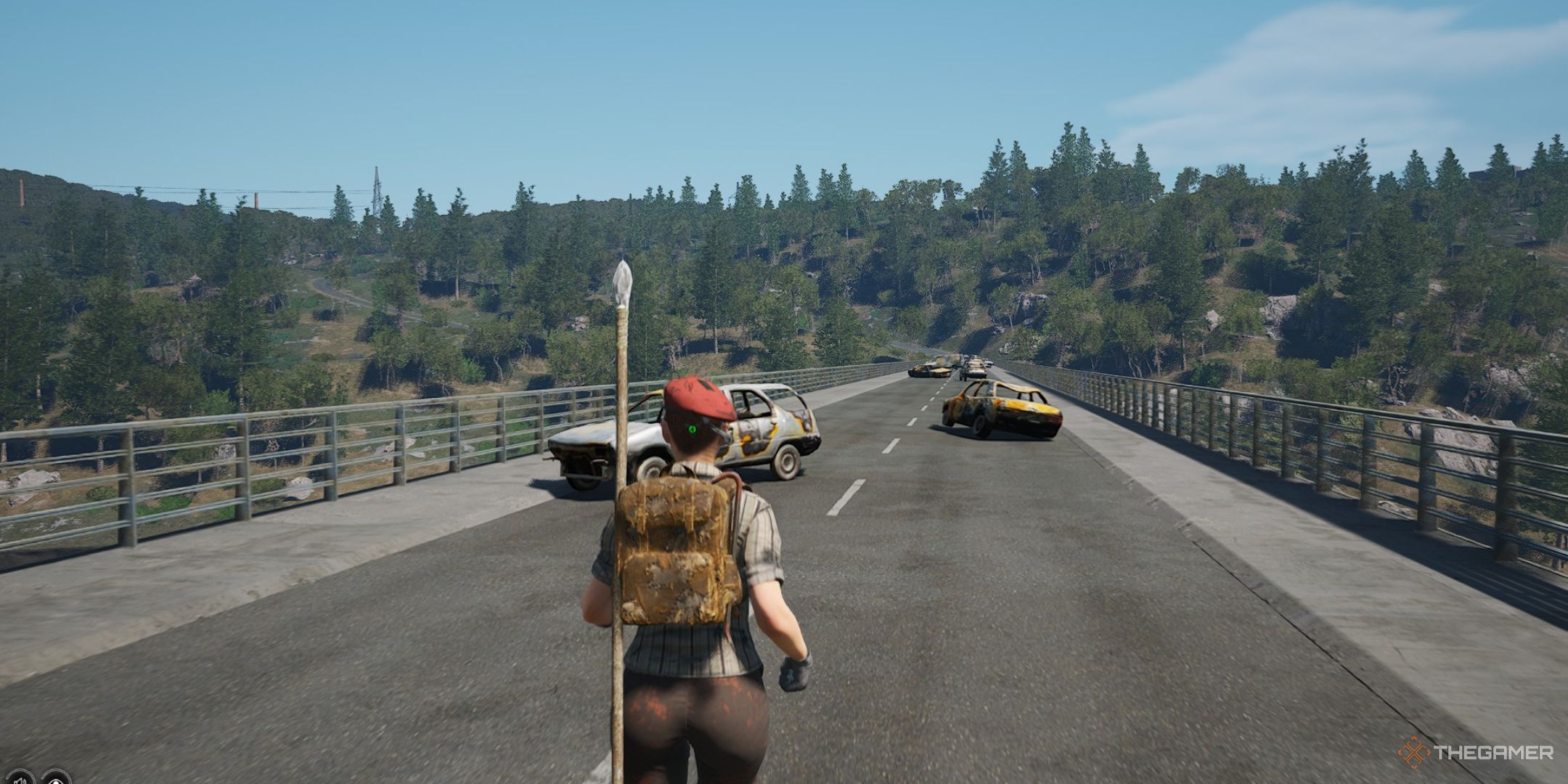 a prisoner in a red beret crosses a bridge covered in abandoned cars in scum.