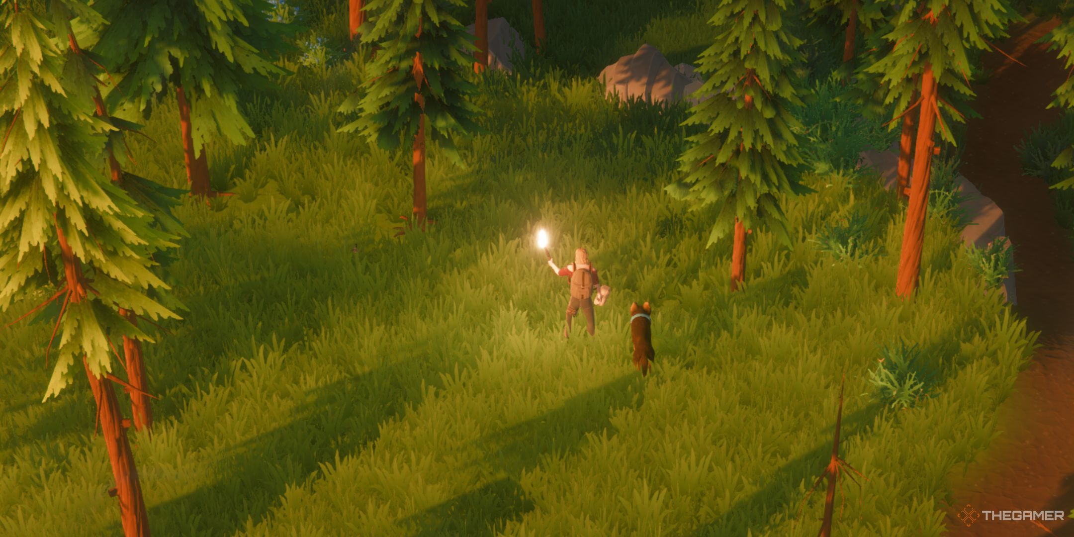 The player is holding a torch and standing around the greenery in Len's Island.