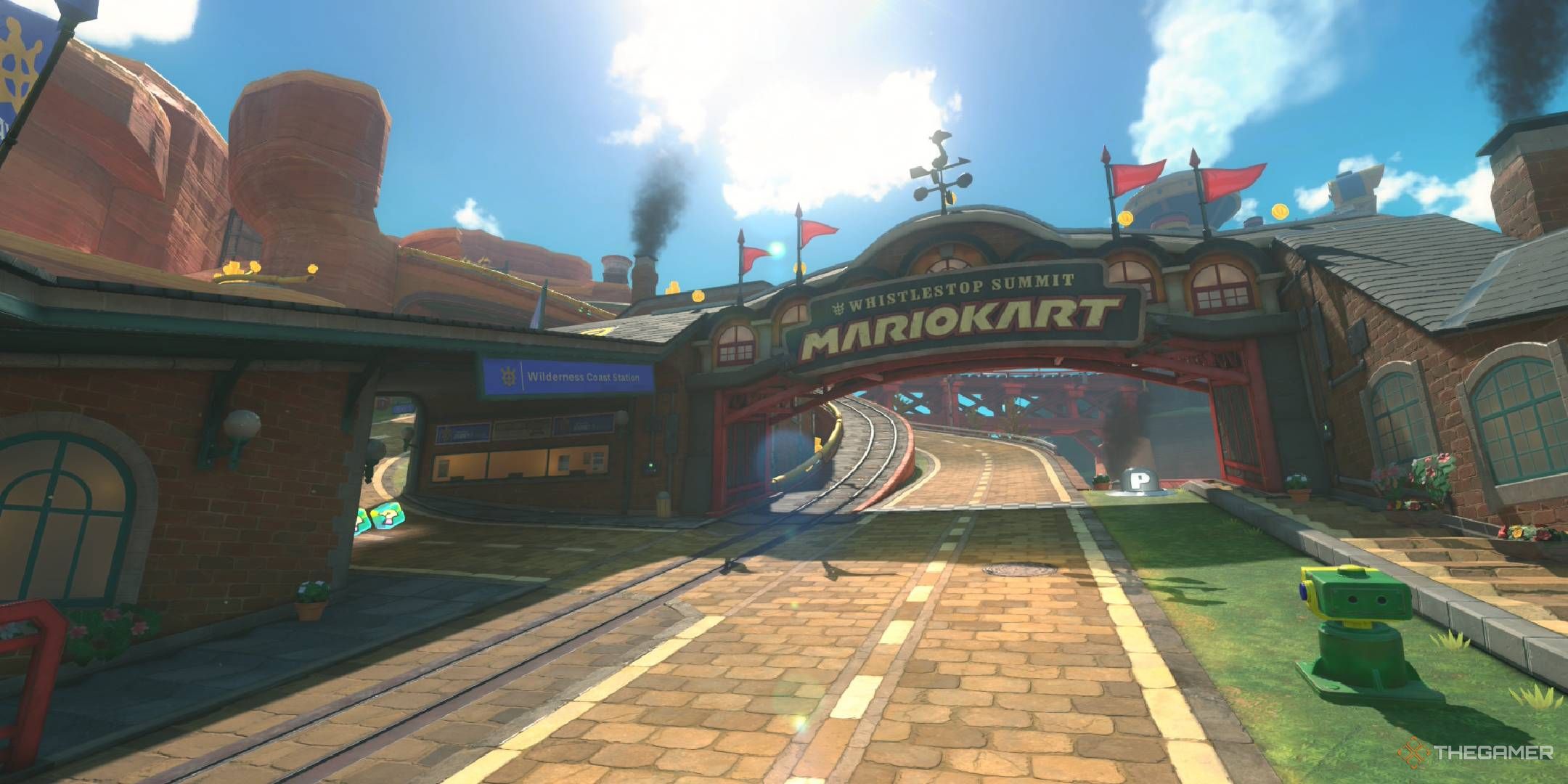 Whistlestop Summit starting line themed as a train station with train tracks on the side from Mario Kart World.