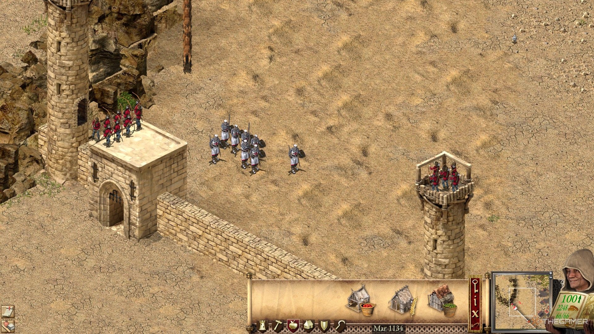 a group of swordsmen and archers defend a gatehouse in stronghold crusader: definitive edition.