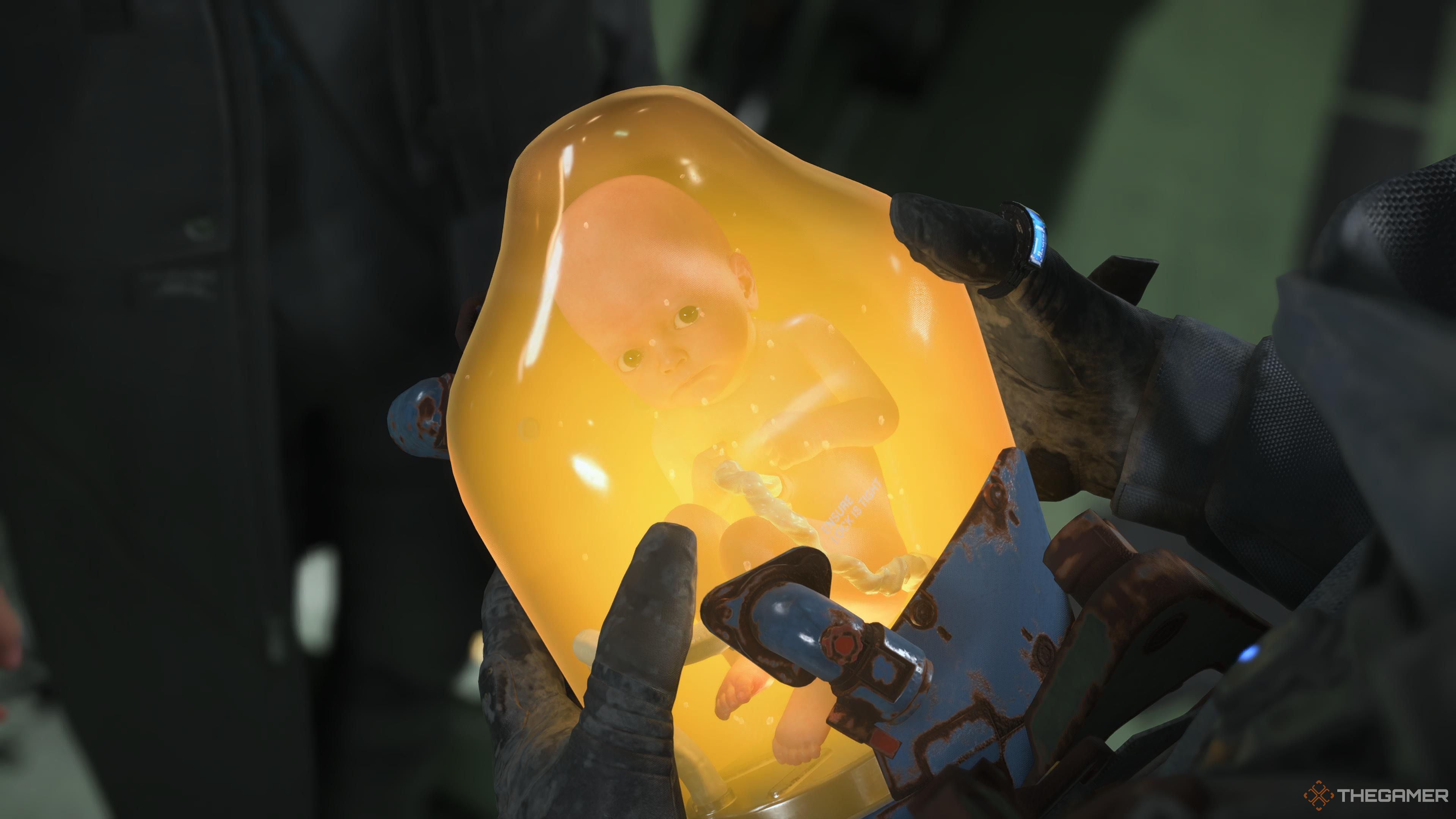 Sam holding Lou in the BB pod in death stranding 2 on the beach.